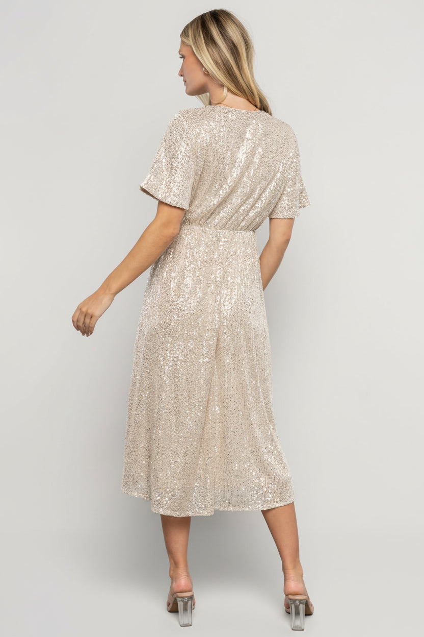 Back view showing rear silhouette, short sleeve coverage, and the lined midi skirt's graceful drape on the model.