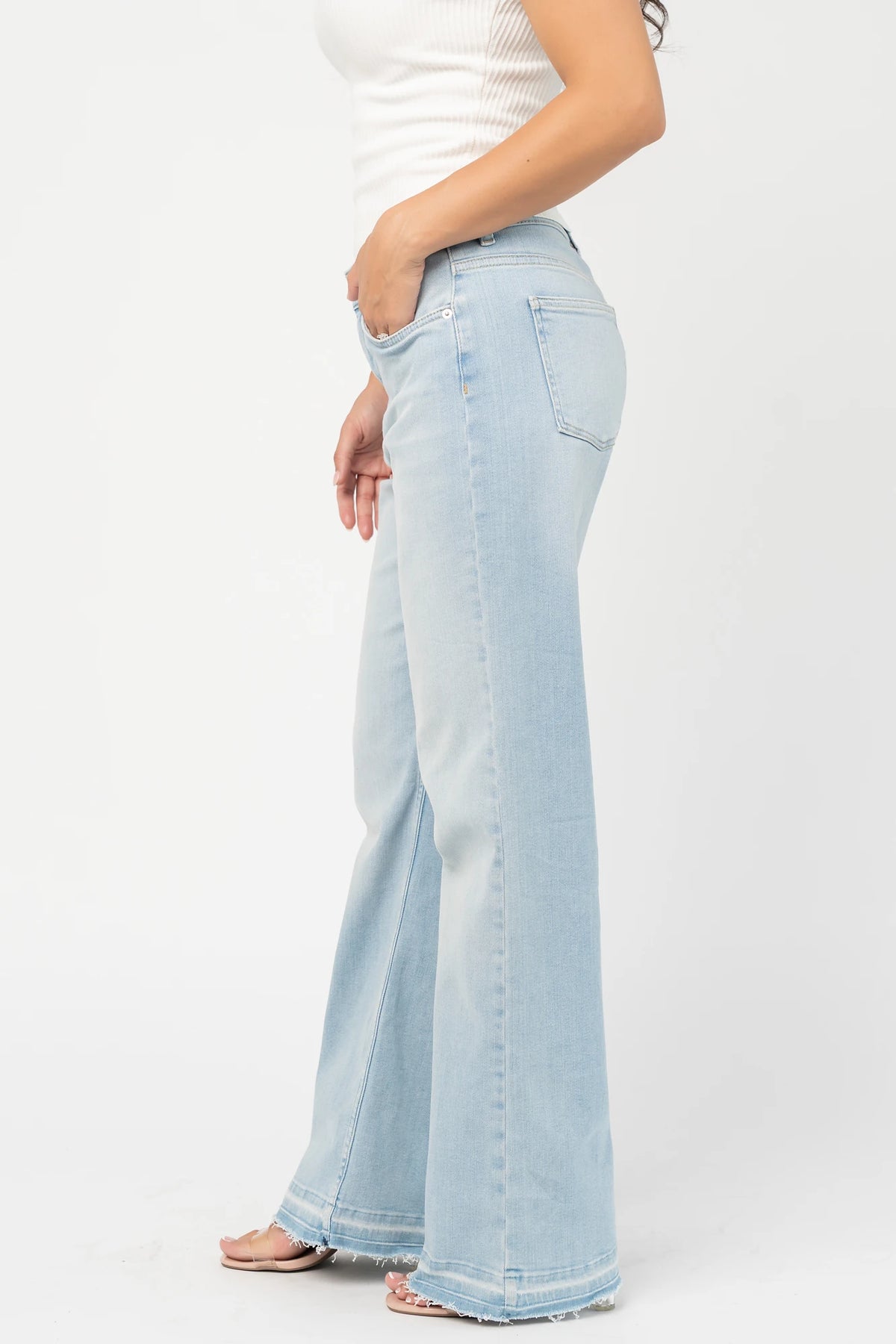 Bria High Rise Wide Leg Jeans in Light Wash with relaxed wide legs, front and back pockets, button closure, and raw hem.