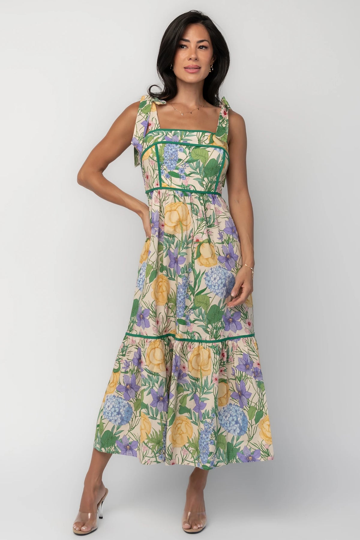 Model wearing the Torres Midi Dress featuring a multicolor floral print with green accents.