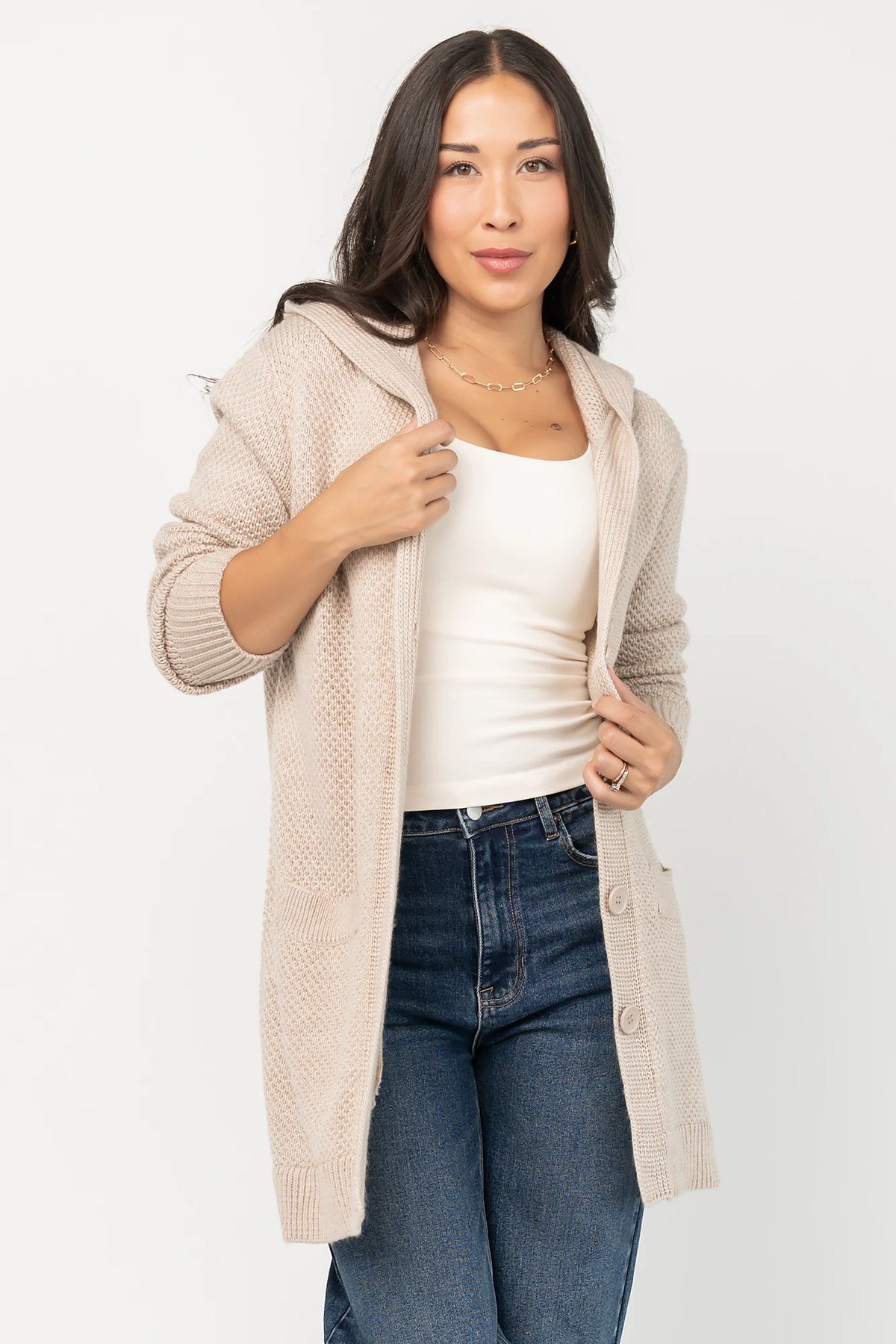 Katrine Hooded Cardigan with chunky knit, oversized fit, four-button front, patch pockets, and ribbed trim.