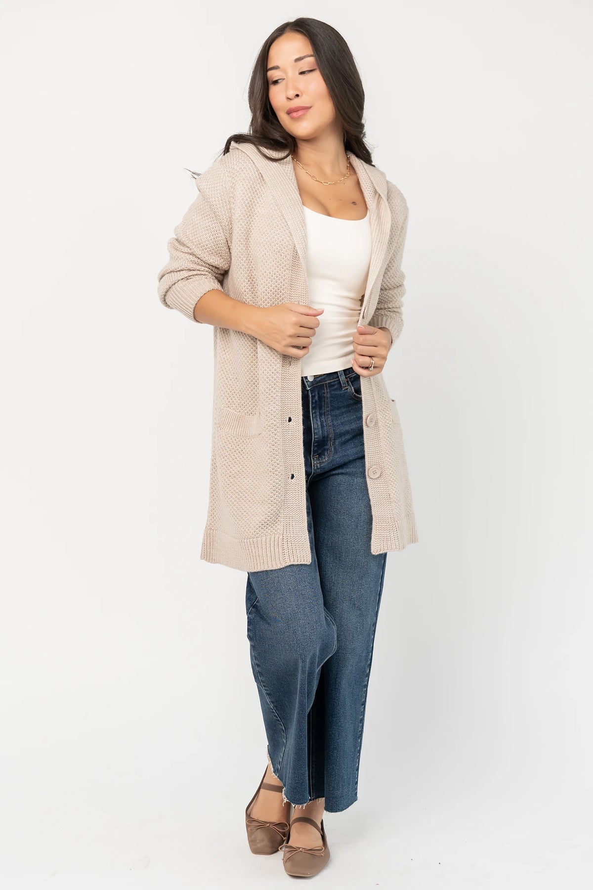 Katrine Hooded Cardigan with chunky knit, oversized fit, four-button front, patch pockets, and ribbed trim.