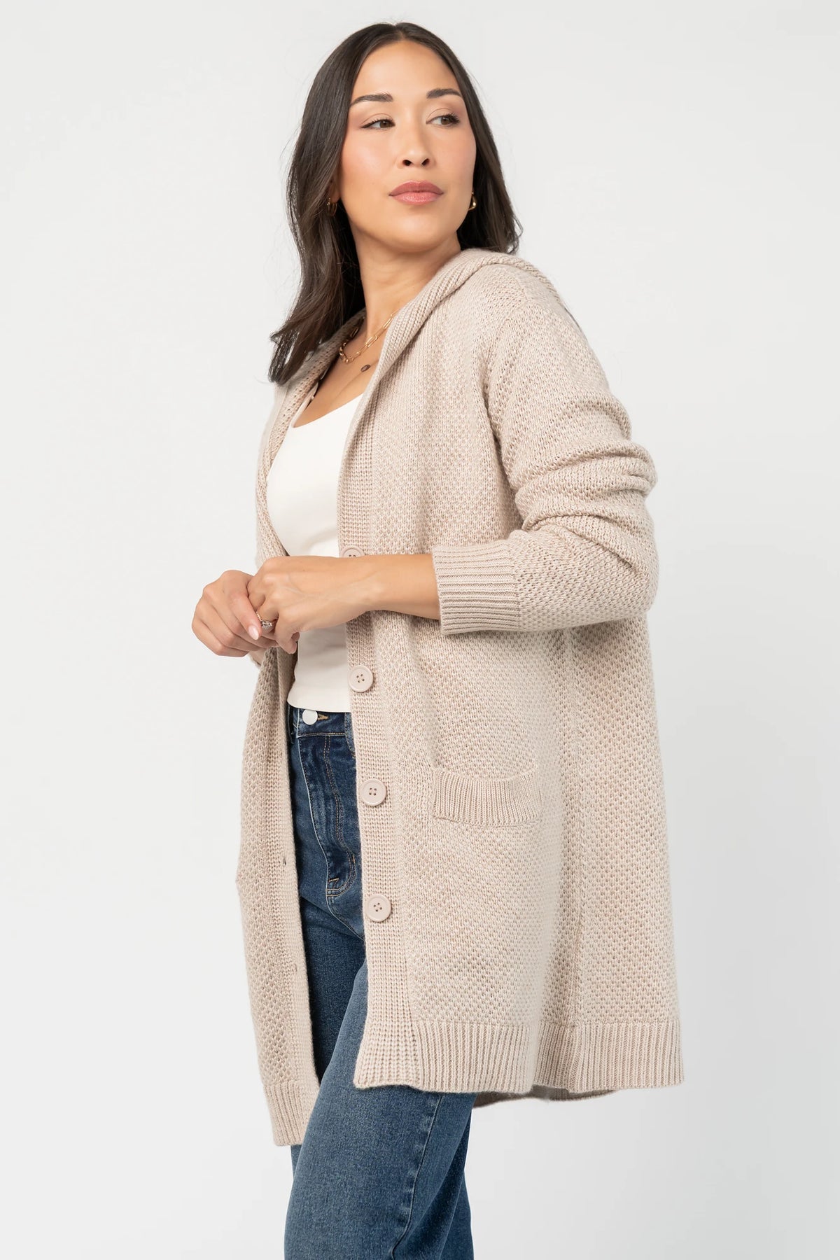 Katrine Hooded Cardigan with chunky knit, oversized fit, four-button front, patch pockets, and ribbed trim.