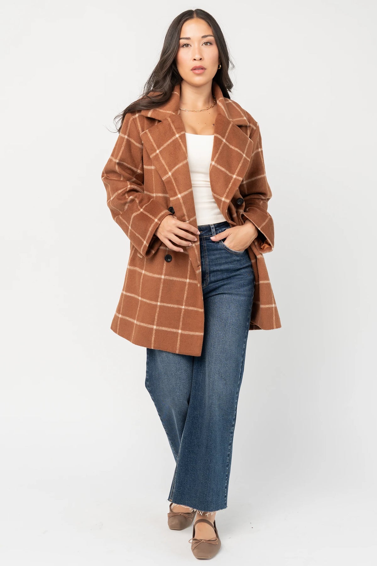 Cognac plaid mid-length coat with a cream windowpane pattern, tailored collar, button-front closure, long sleeves, front pockets, and a fully lined interior.