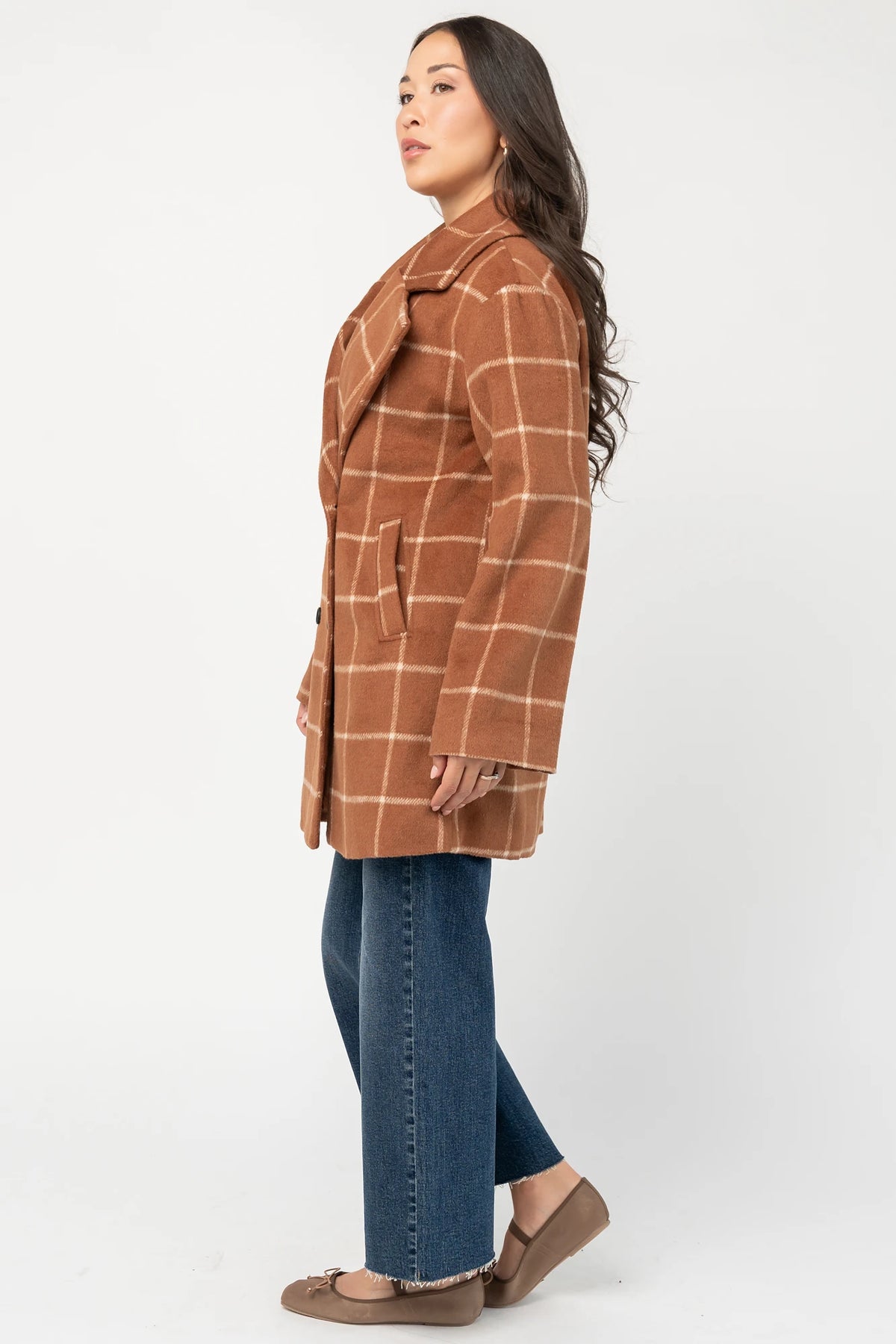 Cognac plaid mid-length coat with a cream windowpane pattern, tailored collar, button-front closure, long sleeves, front pockets, and a fully lined interior.