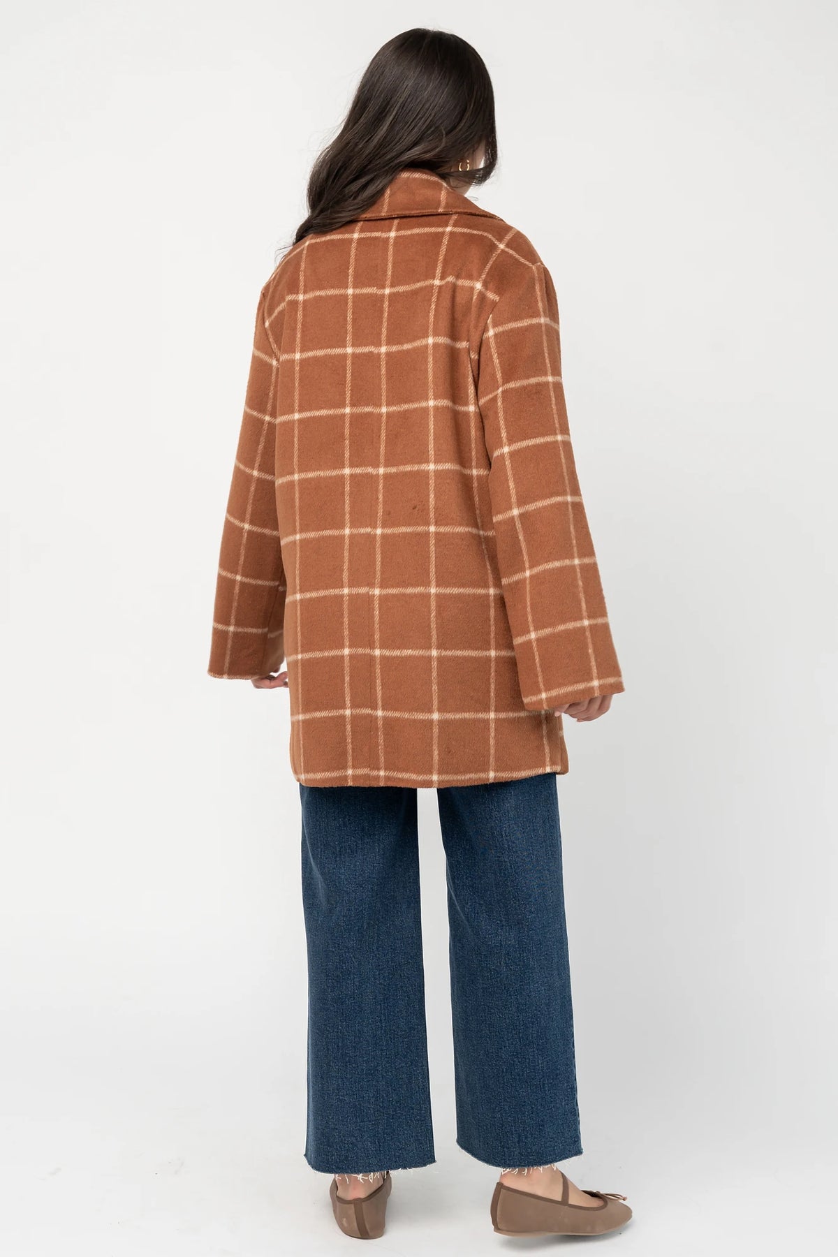 Cognac plaid mid-length coat with a cream windowpane pattern, tailored collar, button-front closure, long sleeves, front pockets, and a fully lined interior.