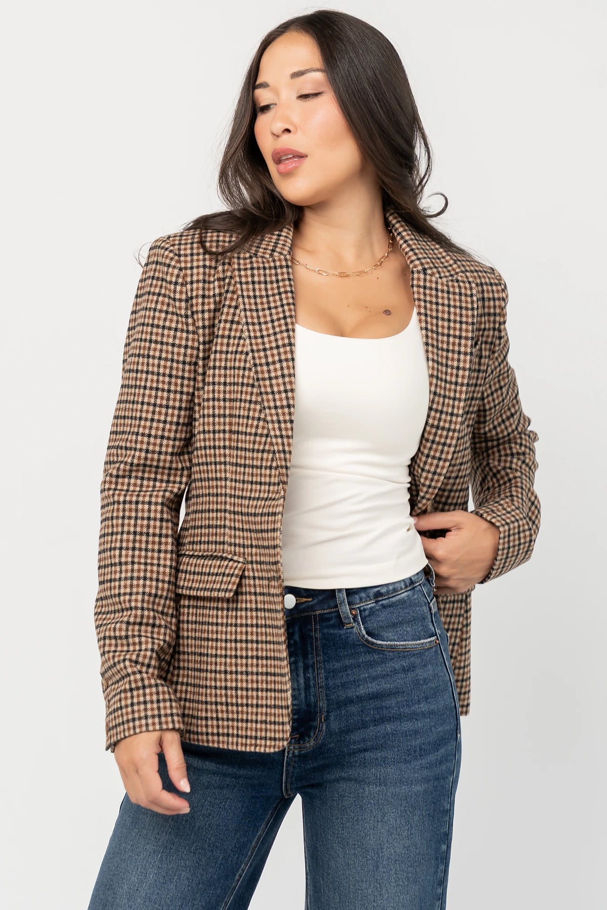 Damien Plaid Blazer in black and camel plaid with tailored waist, two-button front, flap pockets, and long sleeves.