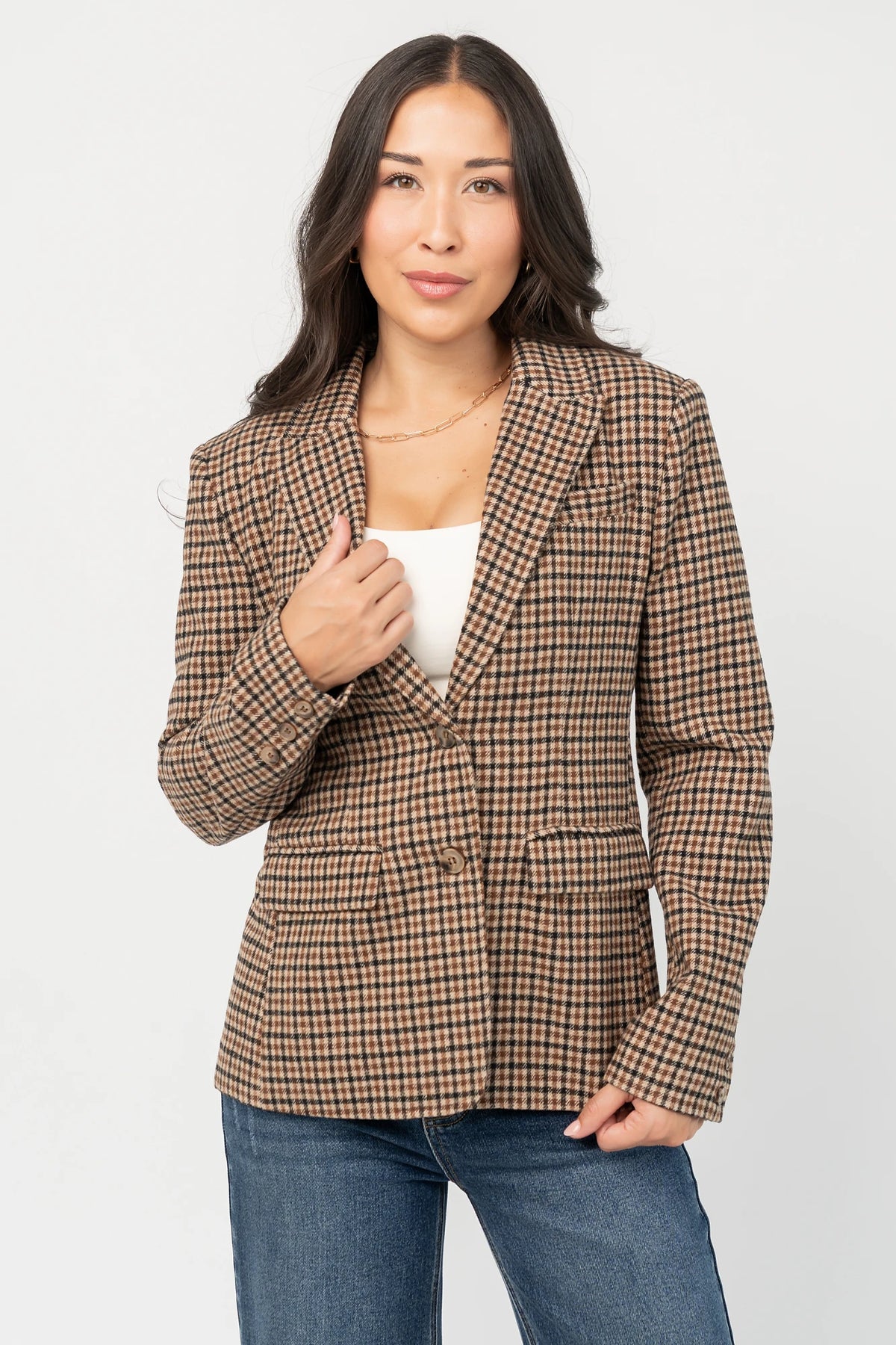 Damien Plaid Blazer in black and camel plaid with tailored waist, two-button front, flap pockets, and long sleeves.