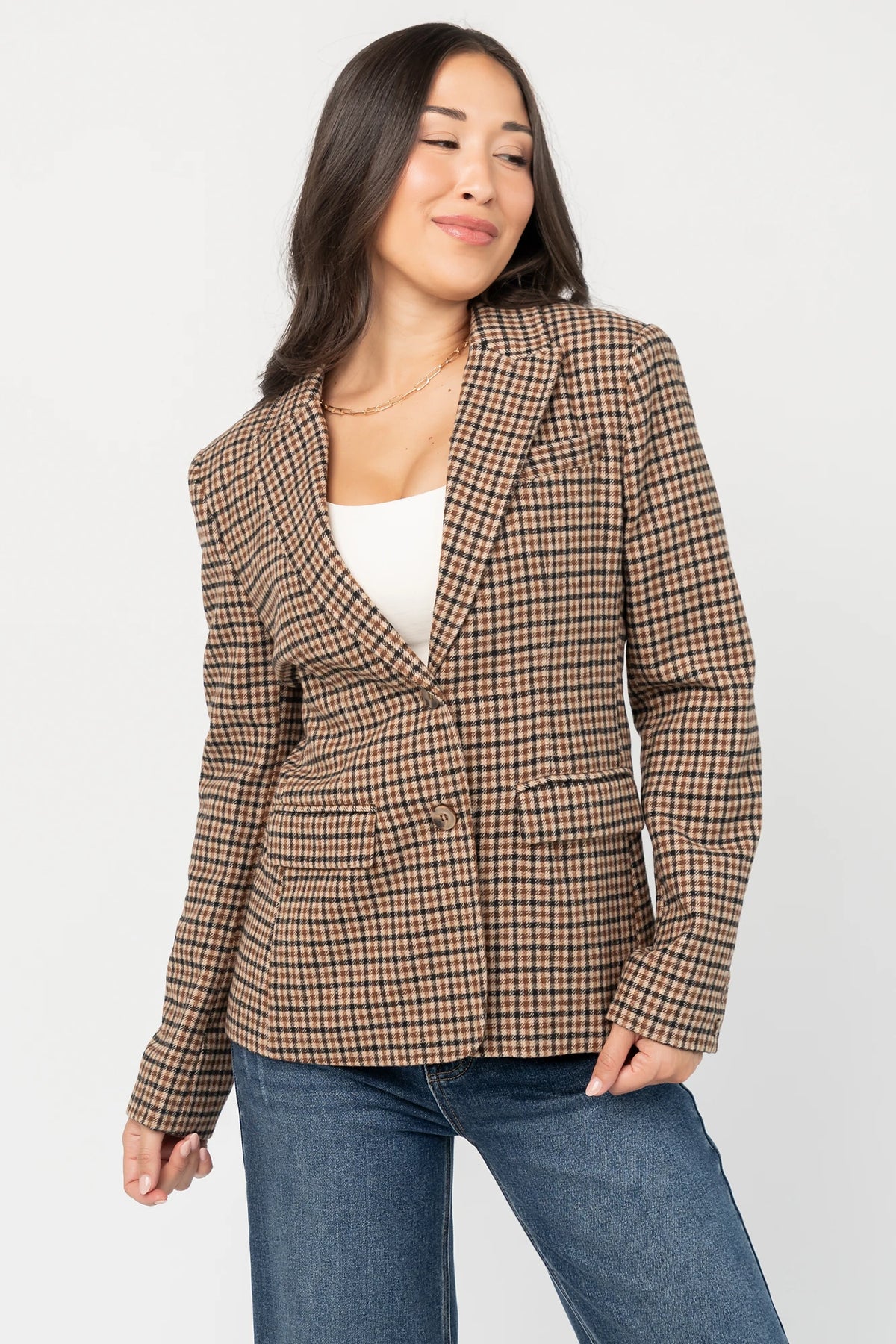 Damien Plaid Blazer in black and camel plaid with tailored waist, two-button front, flap pockets, and long sleeves.