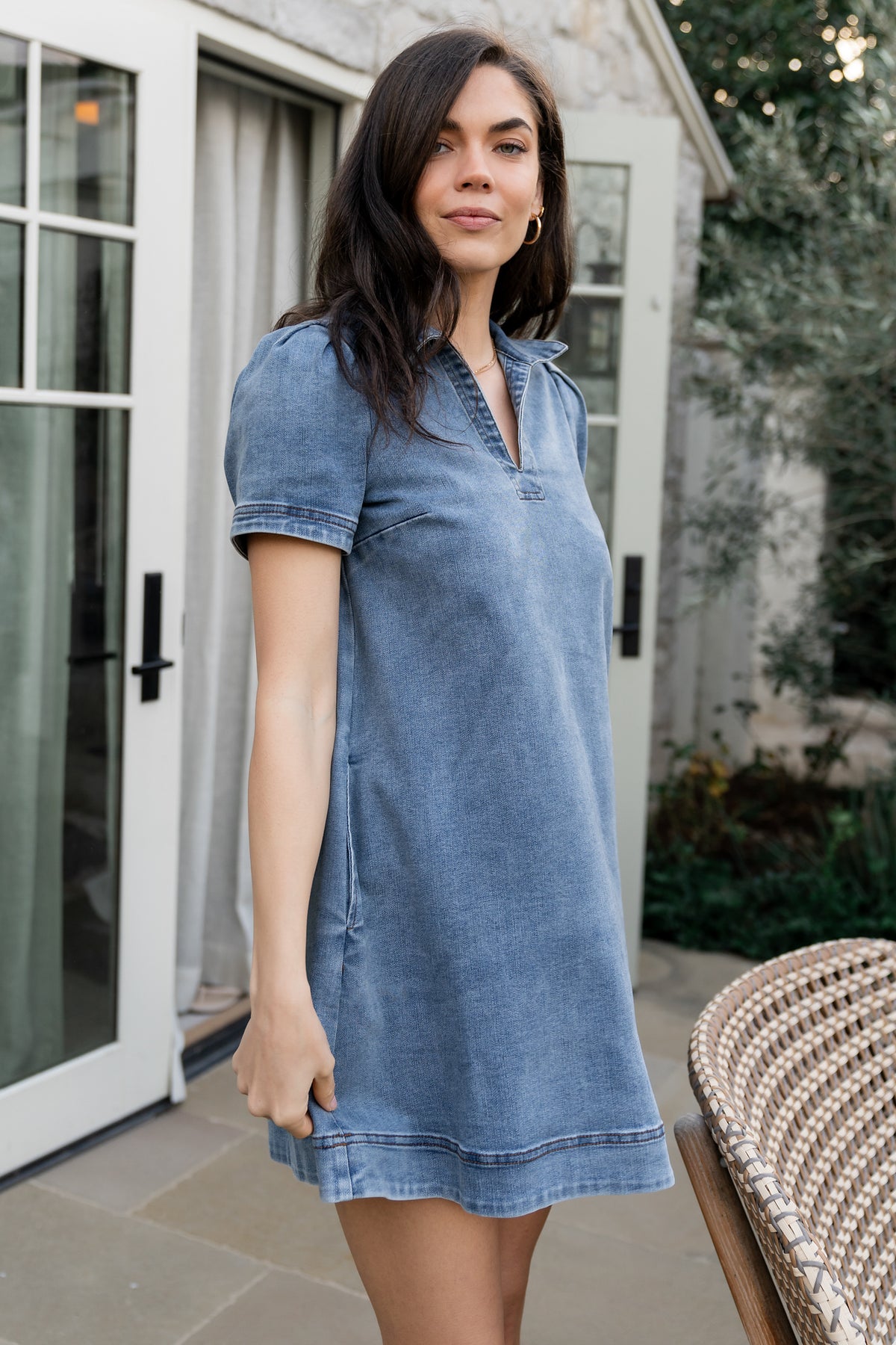 Styled flat-lay of Saylor short denim dress showing neckline, sleeve shape, and pocket placement in medium-wash denim.