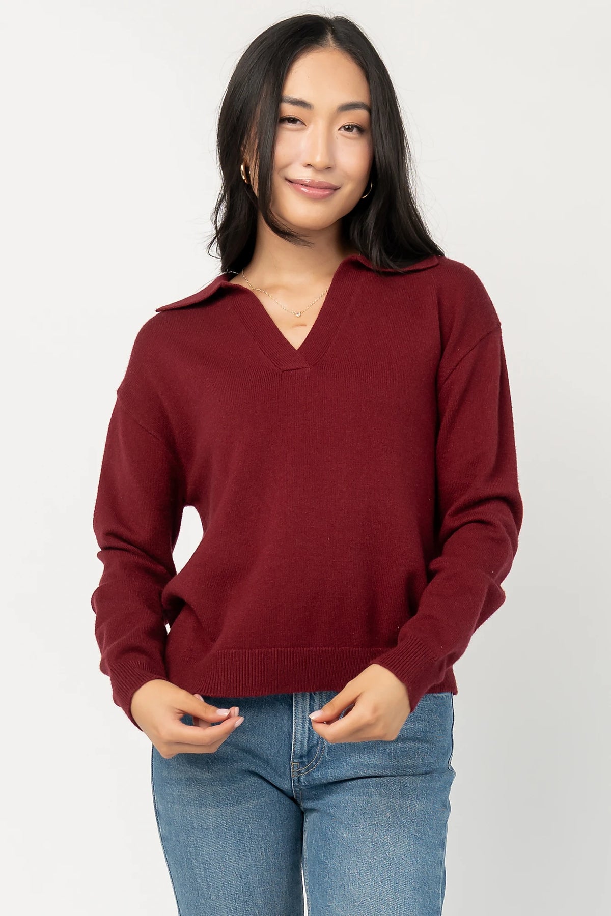 Bodhi Sweater with open rugby-style collar, dropped shoulders, long sleeves, and ribbed cuffs and hem.