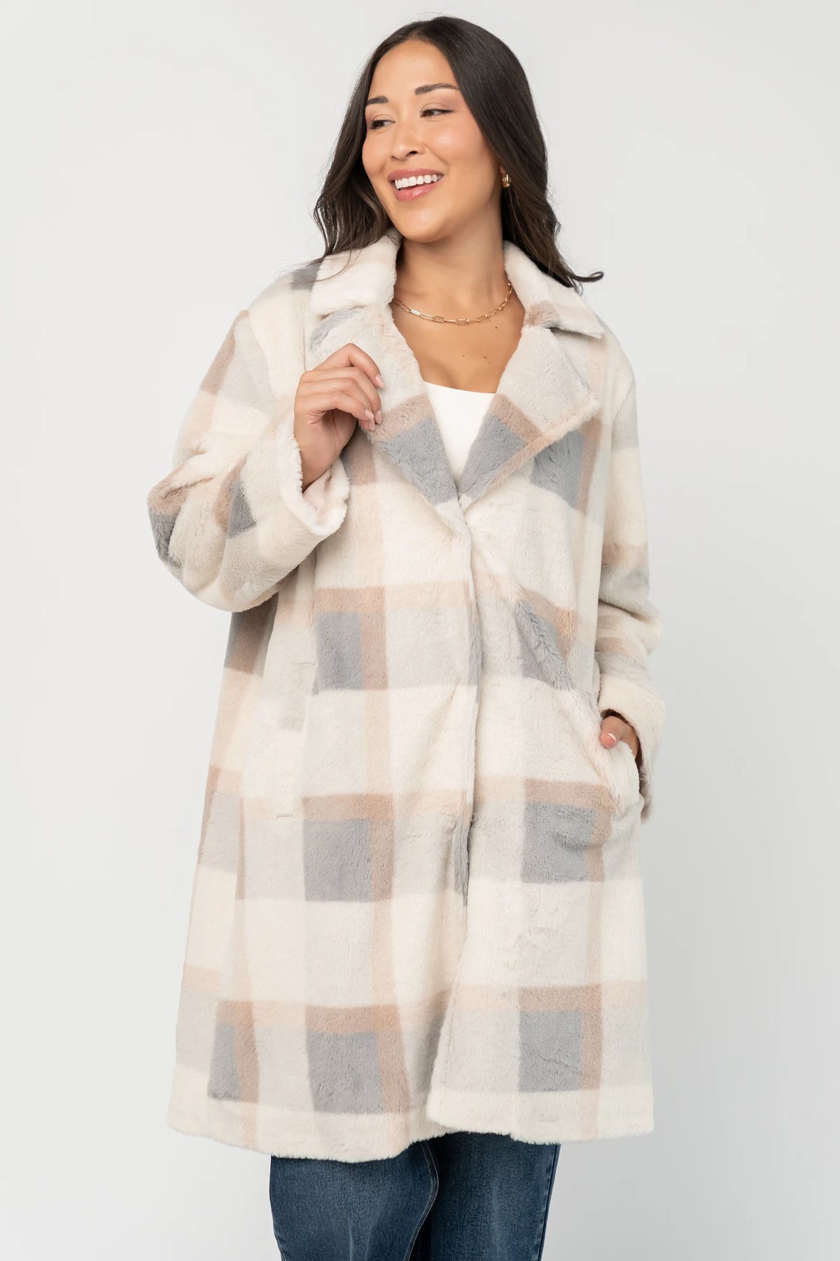 Natural plaid faux fur mid-length coat with taupe and gray accents, notched collar, hidden front snap closure, long sleeves, functional side pockets, and a fully lined interior.