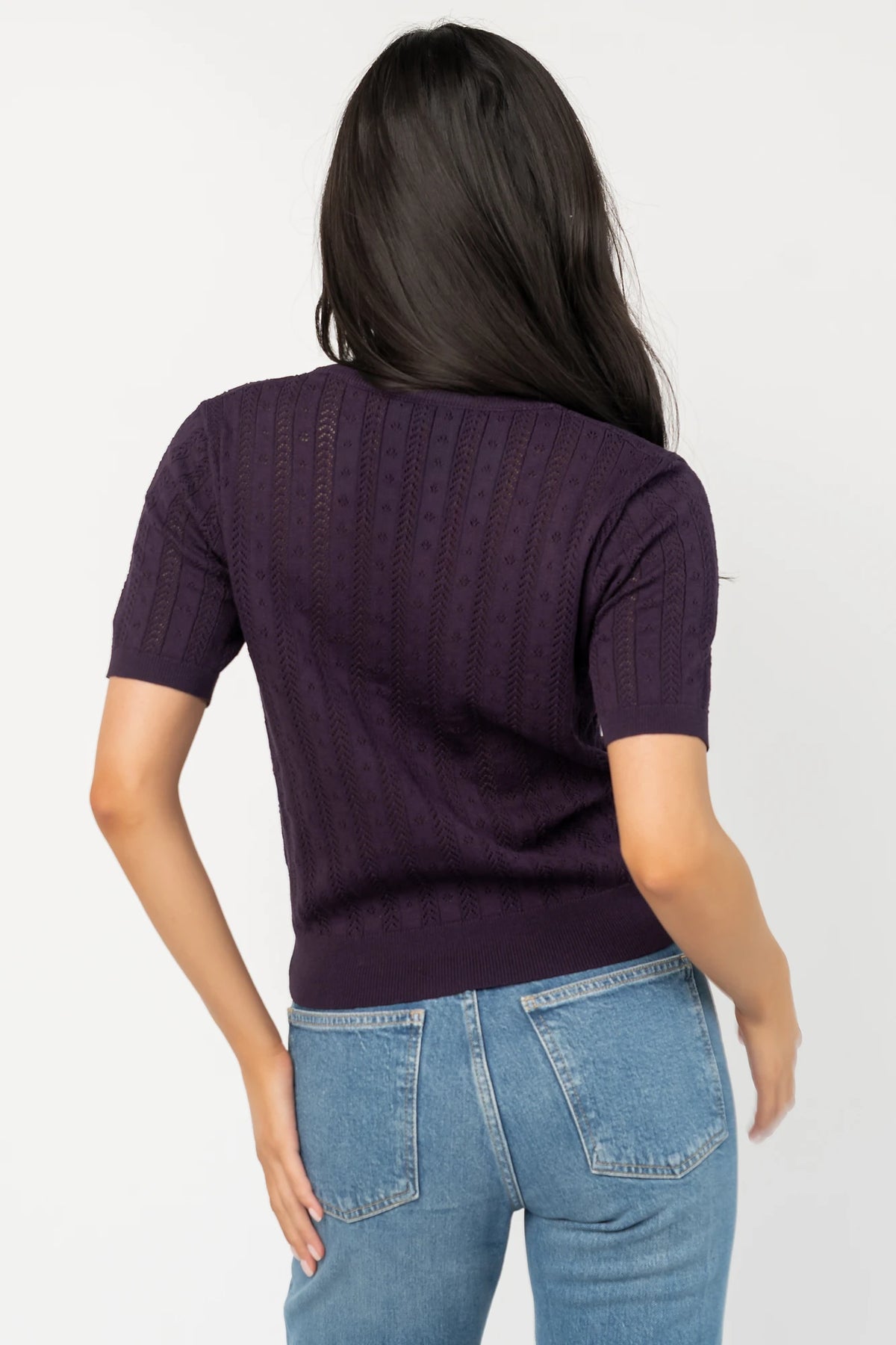 Perry Knit Top in Plum with pointelle texture, notched crew neckline, short sleeves, and ribbed hem and cuffs.