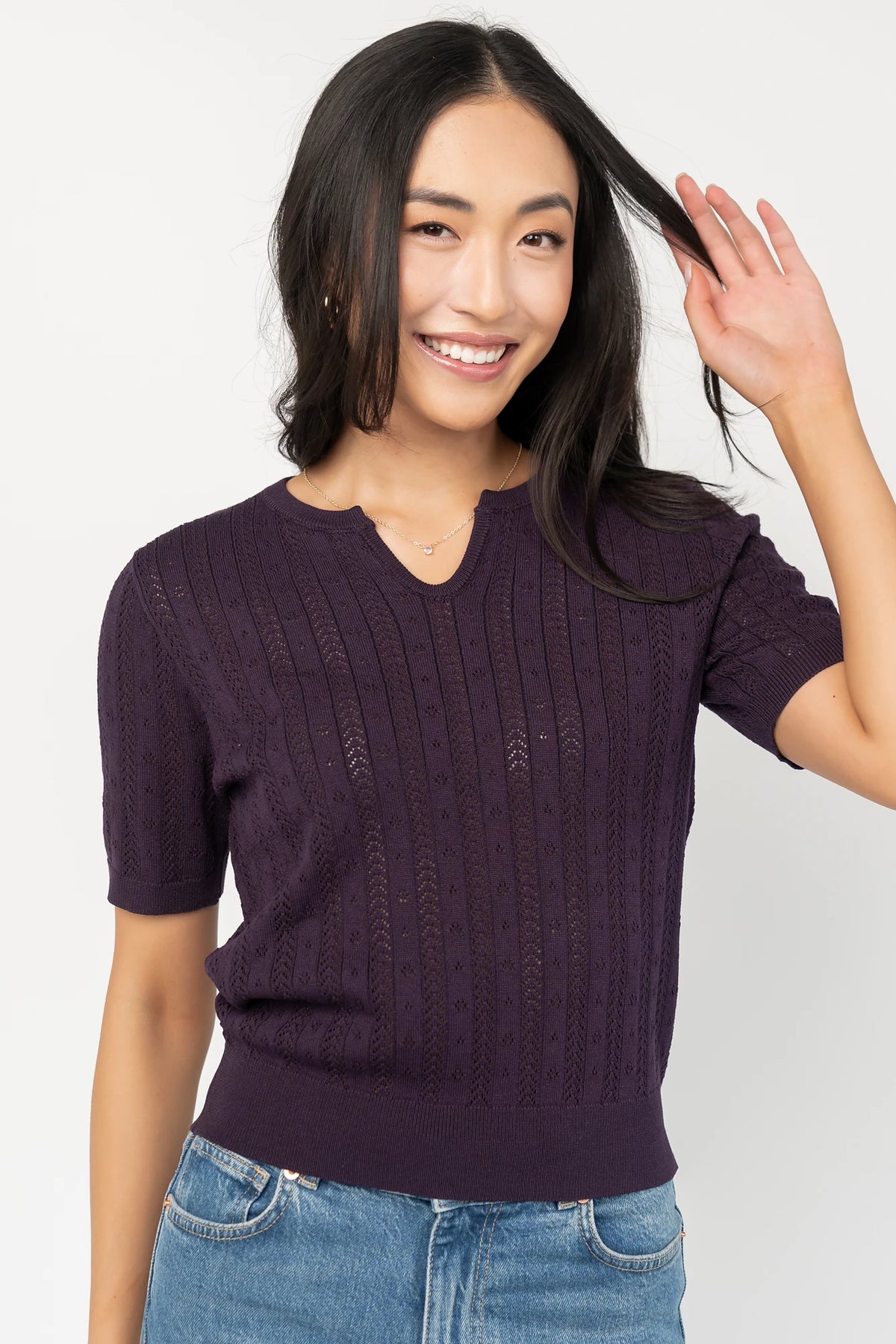 Perry Knit Top in Plum with pointelle texture, notched crew neckline, short sleeves, and ribbed hem and cuffs.