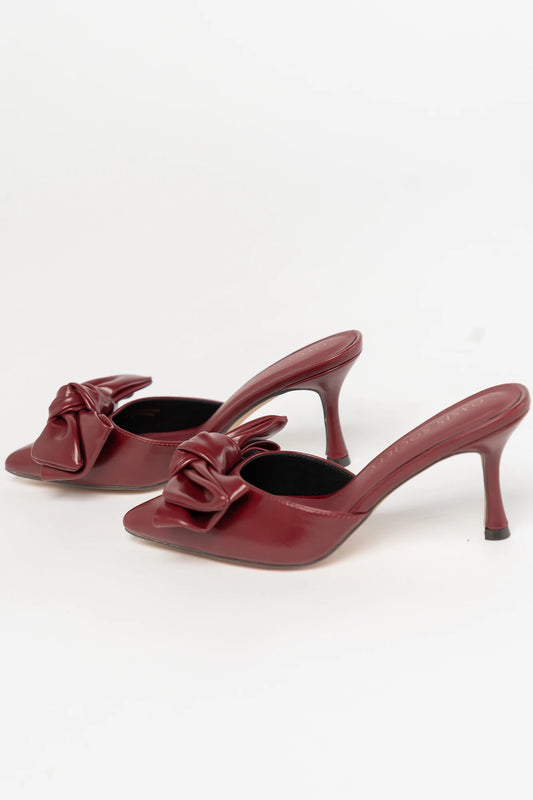 Montara Pointed Toe Kitten Heel in Burgundy with faux leather finish, statement bow, slip-on mule design, and kitten heel.
