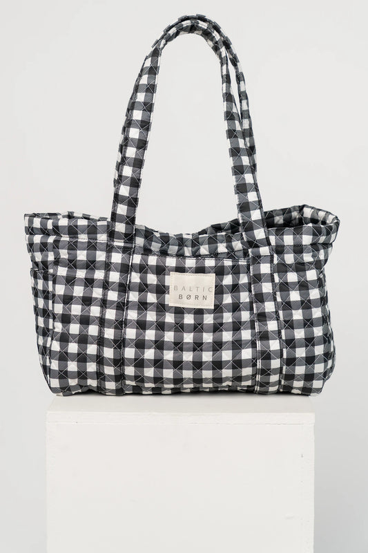 Sedona Gingham Tote Bag in Black with quilted black and white gingham, shoulder straps, snap closure, and interior zip pocket.