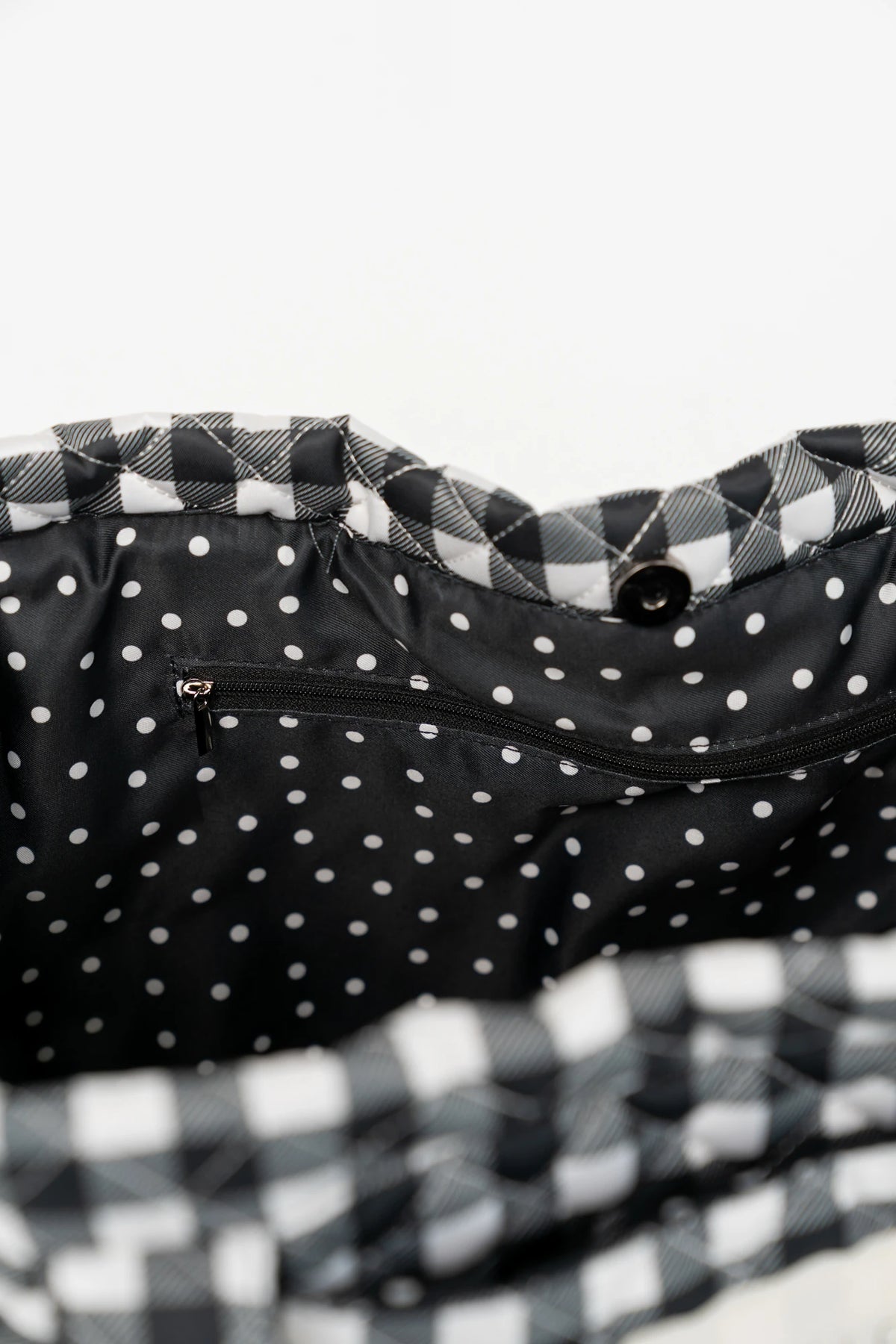 Sedona Gingham Tote Bag in Black with quilted black and white gingham, shoulder straps, snap closure, and interior zip pocket.