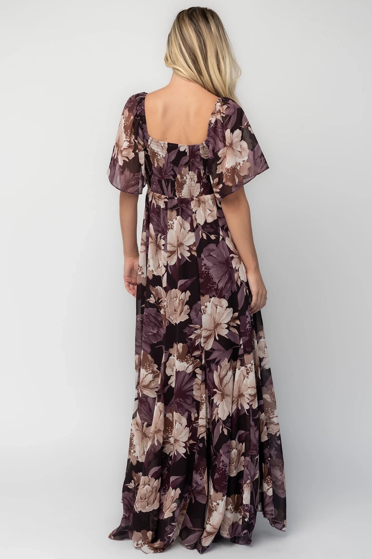 Positano Maxi Dress in Dusty Plum Floral with sweetheart neckline, flutter sleeves, smocked back, and tiered skirt.
