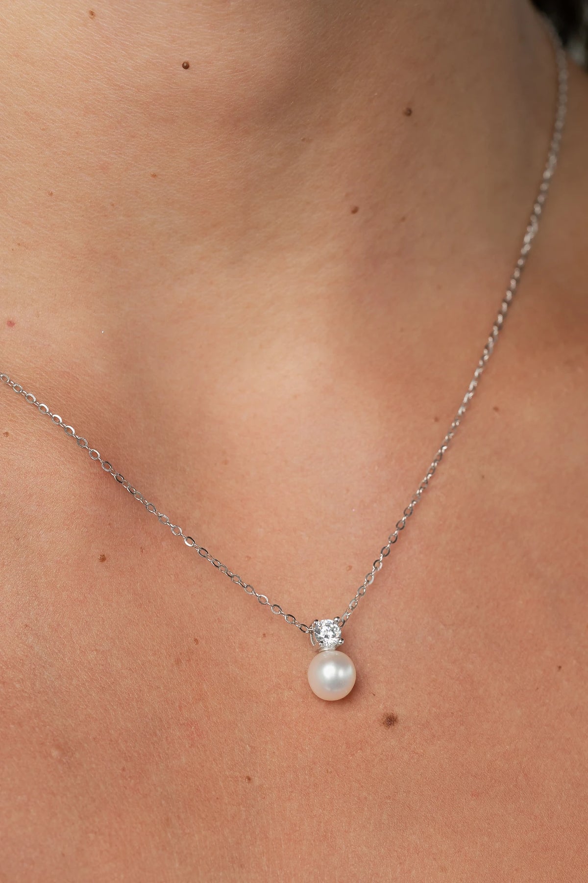 Addilyn Pearl Necklace in Silver with freshwater pearl pendant, moissanite accent, and delicate silver-tone chain.
