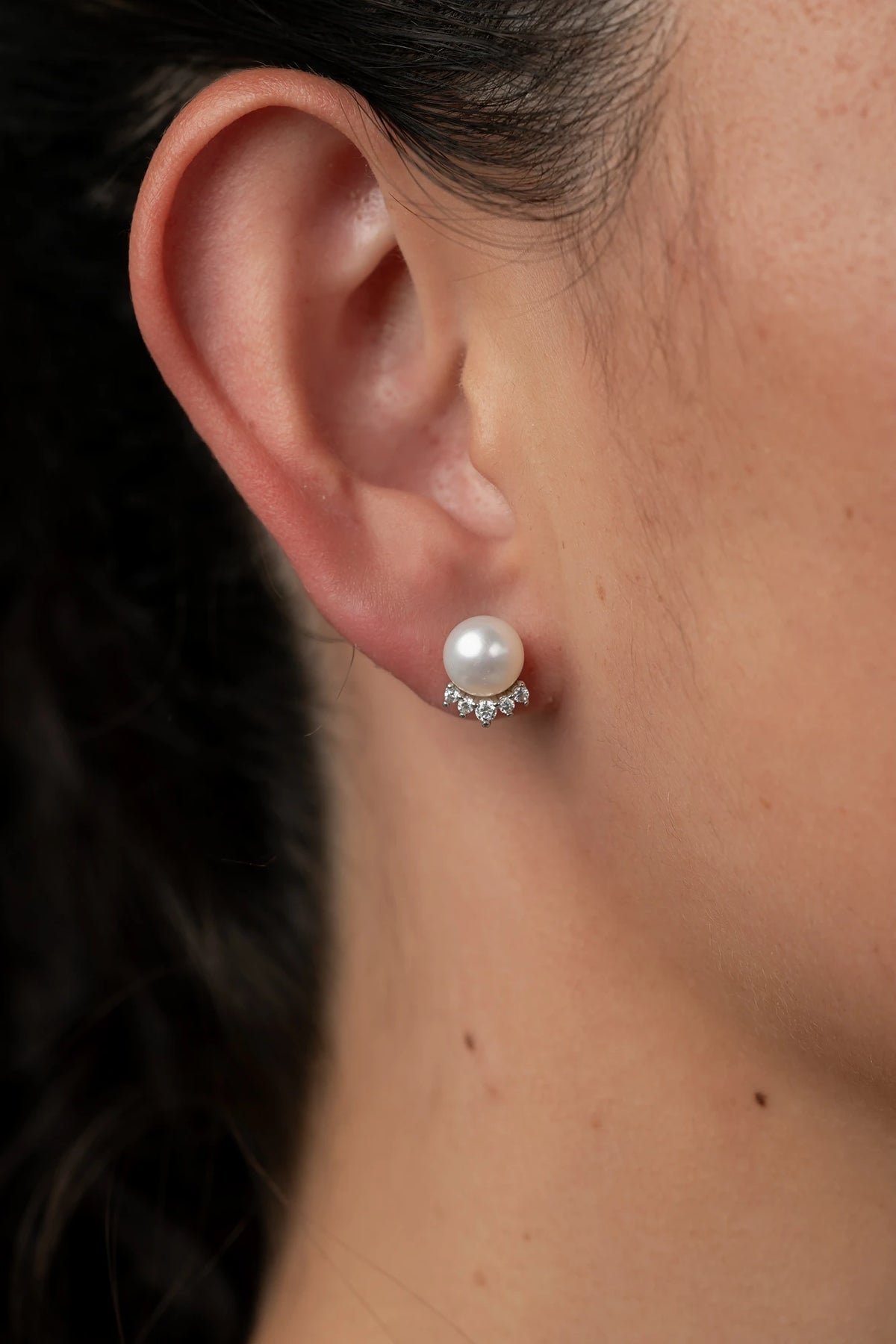 Livvy Pearl Stud Earrings with glossy pearl centers, polished sterling silver settings, and classic post backs.