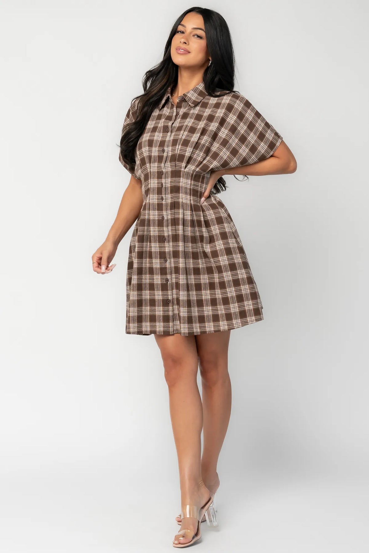 Model wearing a brown plaid short dress with a collared neckline, button-front closure, and short dolman sleeves.