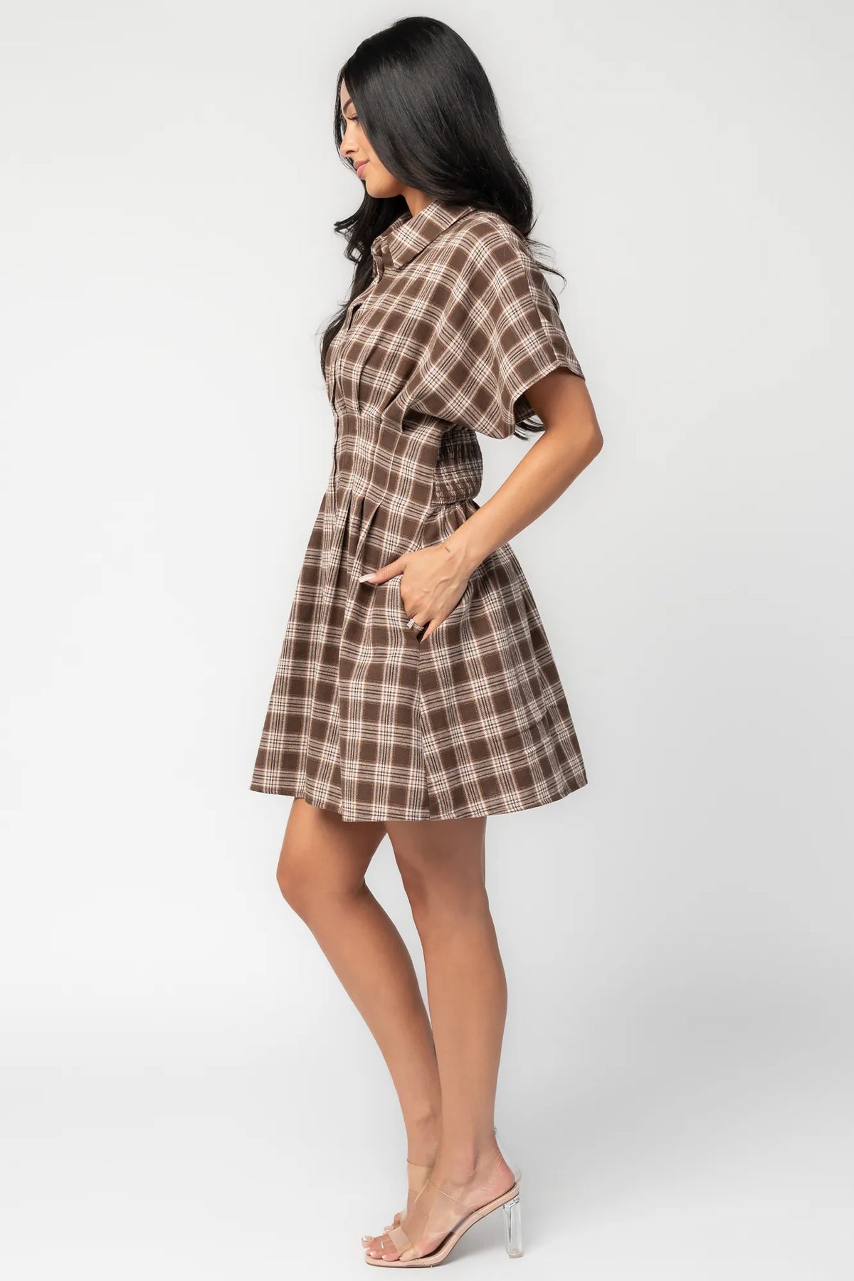 Model wearing a brown plaid short dress with a collared neckline, button-front closure, and short dolman sleeves.