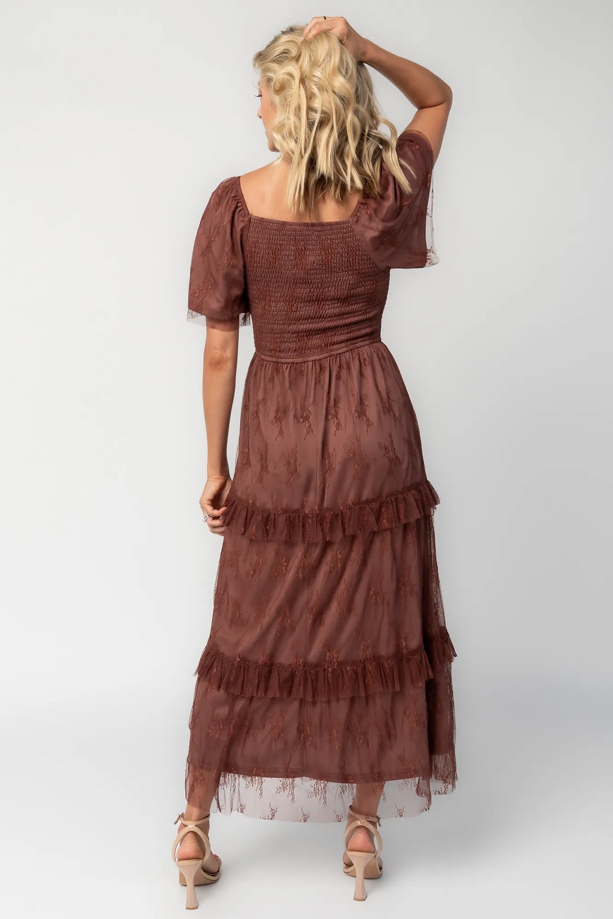 Model wearing a mahogany lace maxi dress with a square neckline, short sleeves, and a smocked bodice.