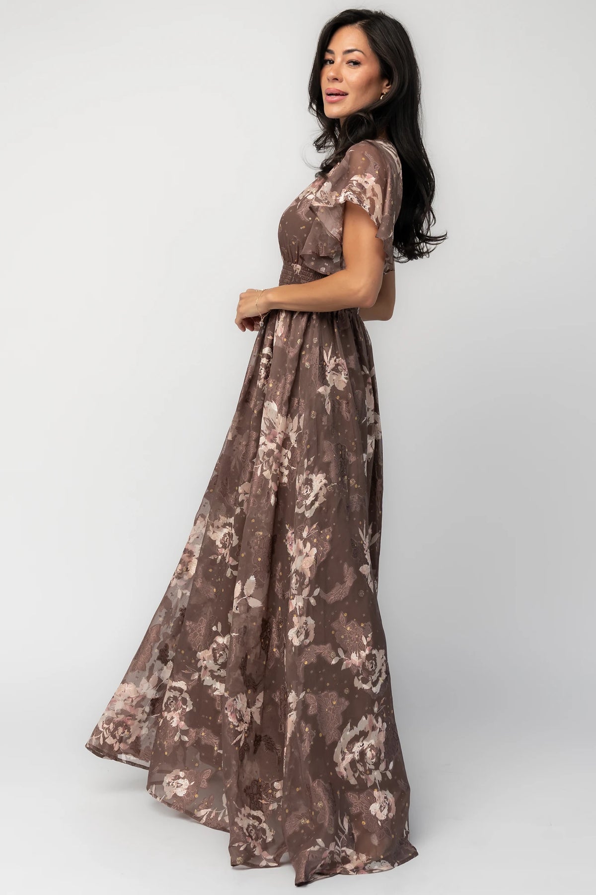 Mocha metallic floral chiffon maxi dress with a V-neckline, flutter sleeves, smocked waist, and flowing full-length skirt.