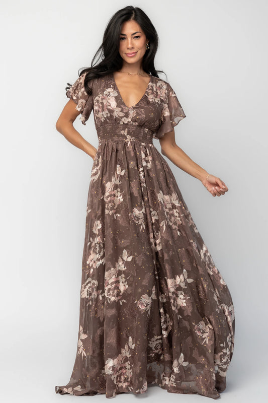 Mocha metallic floral chiffon maxi dress with a V-neckline, flutter sleeves, smocked waist, and flowing full-length skirt.