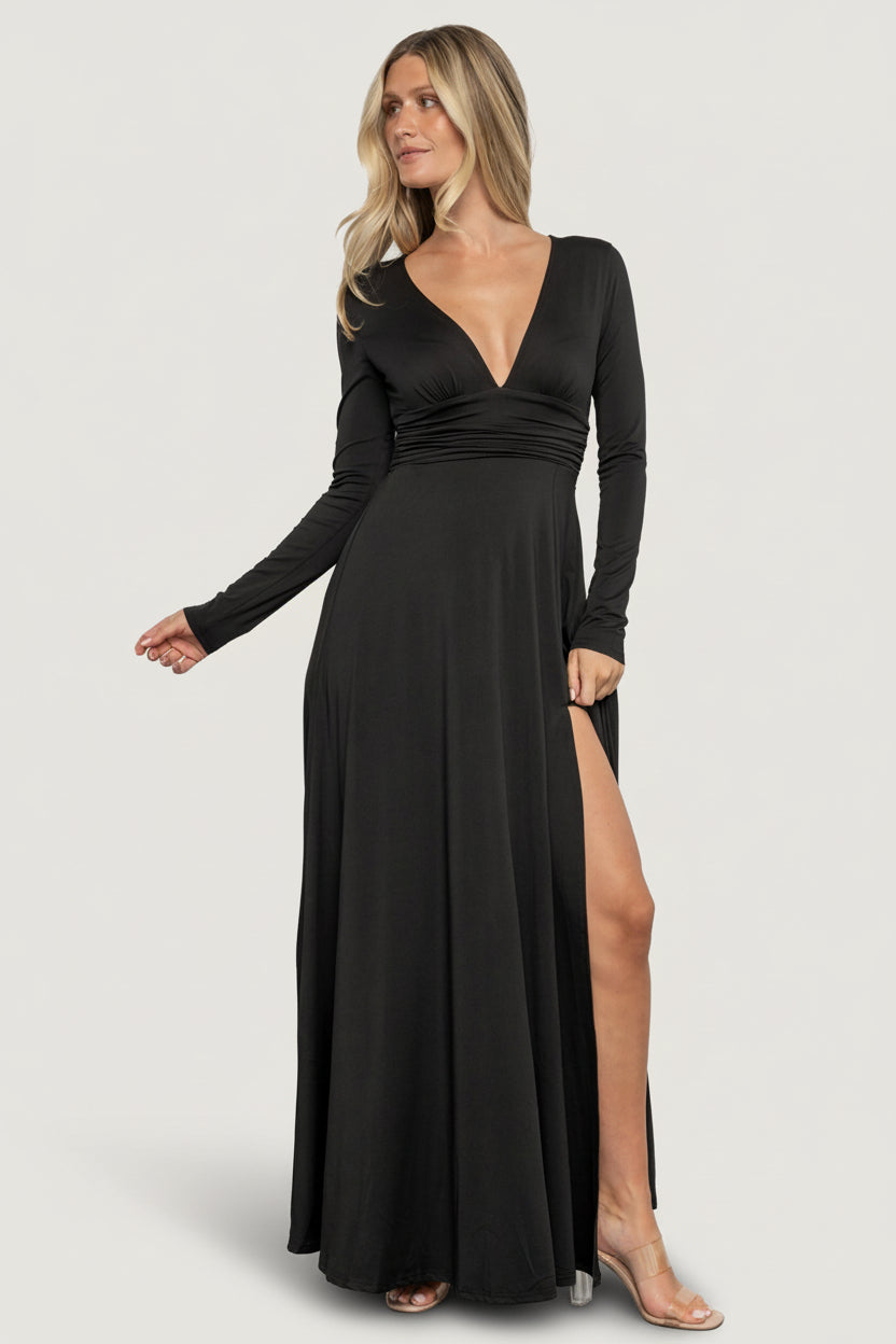 Front view of Arianna Maxi Dress in black on a model, showing deep V-neck, long sleeves, smocked waist and left-side slit, soft stretch fabric.