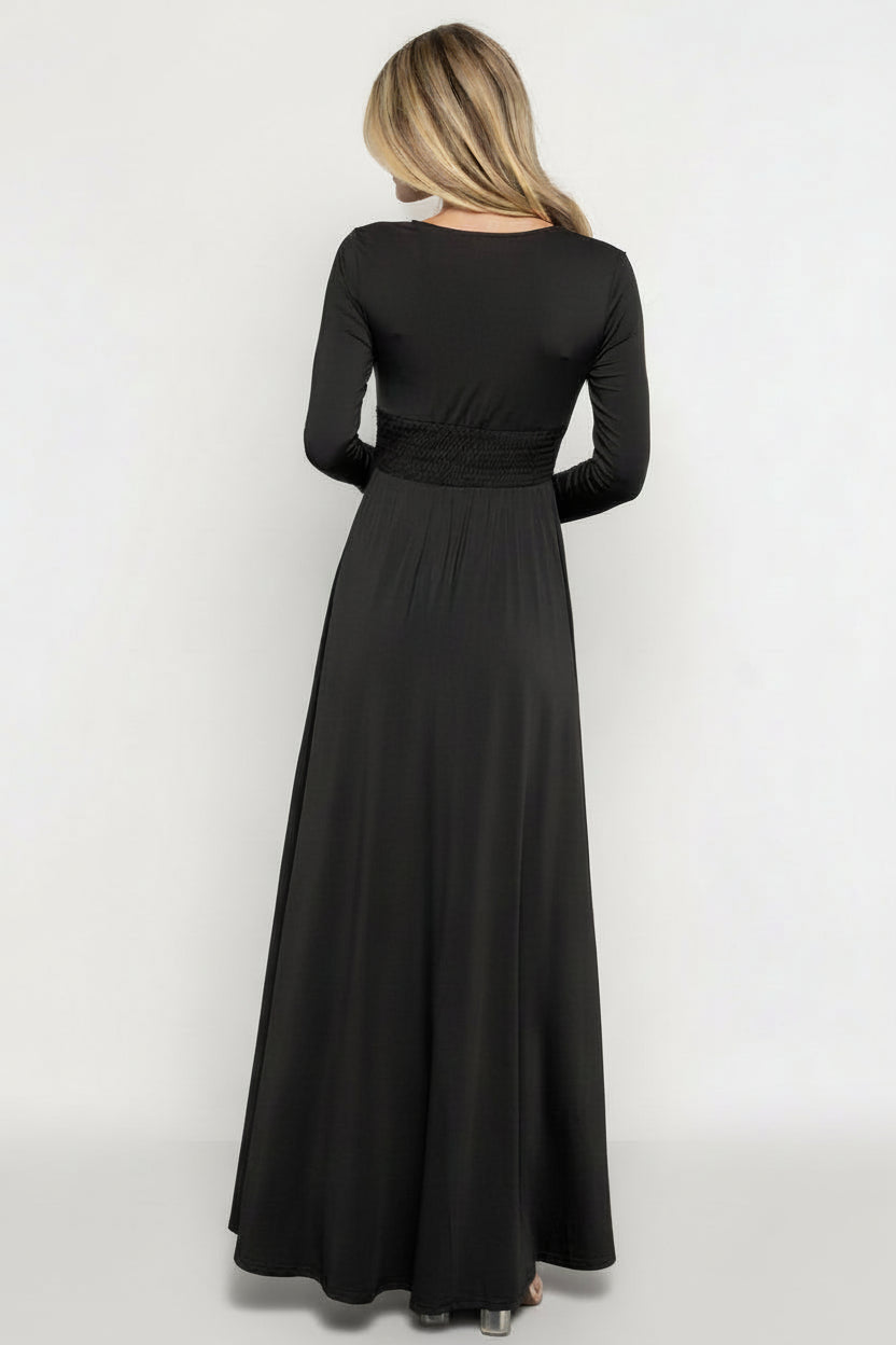 Studio shot of Arianna Maxi Dress in black on mannequin or model, full-length view emphasizing V-neck, long sleeves, and maxi silhouette.