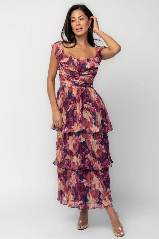 Model wearing the Steinway Pleated Midi Dress in Berry Floral featuring a pink, berry, and mauve floral print on lightweight pleated chiffon.