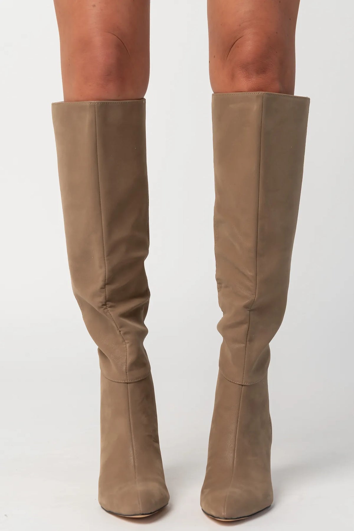 Pair of mocha knee-high boots featuring a pointed toe, sleek fitted shaft, and sculpted kitten heel. The streamlined silhouette and smooth finish create an elegant, versatile look that pairs effortlessly with dresses, skirts, and tailored outfits.