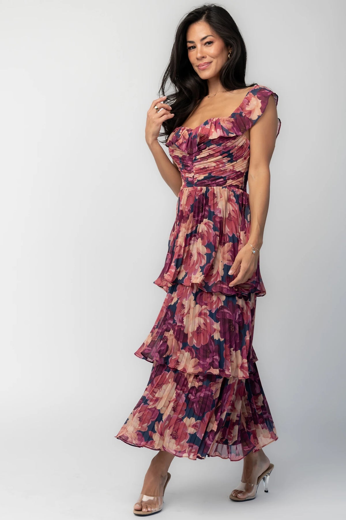 Model wearing the Steinway Pleated Midi Dress in Berry Floral featuring a pink, berry, and mauve floral print on lightweight pleated chiffon.