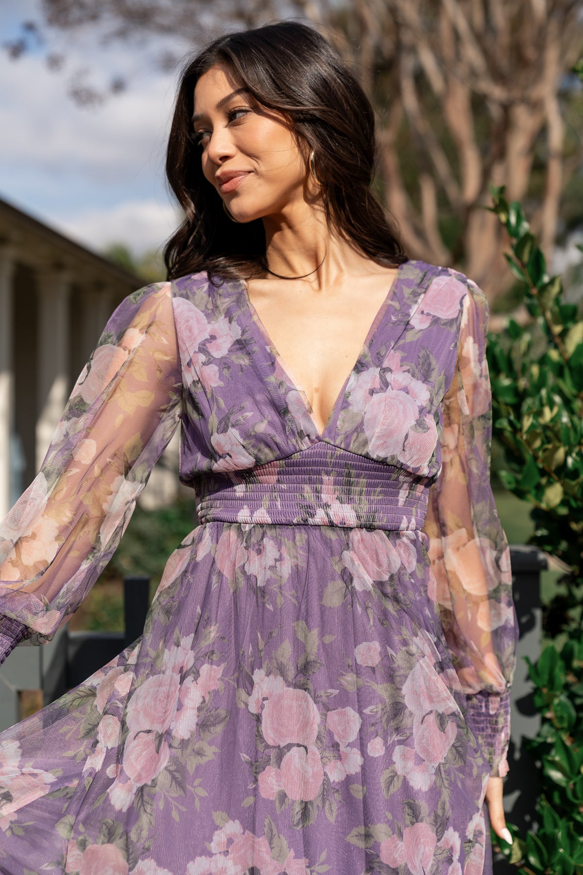 Close-up of Layla dress fabric and blush floral pattern on lavender tulle, highlighting smocked cuff and delicate sheer sleeve detail.