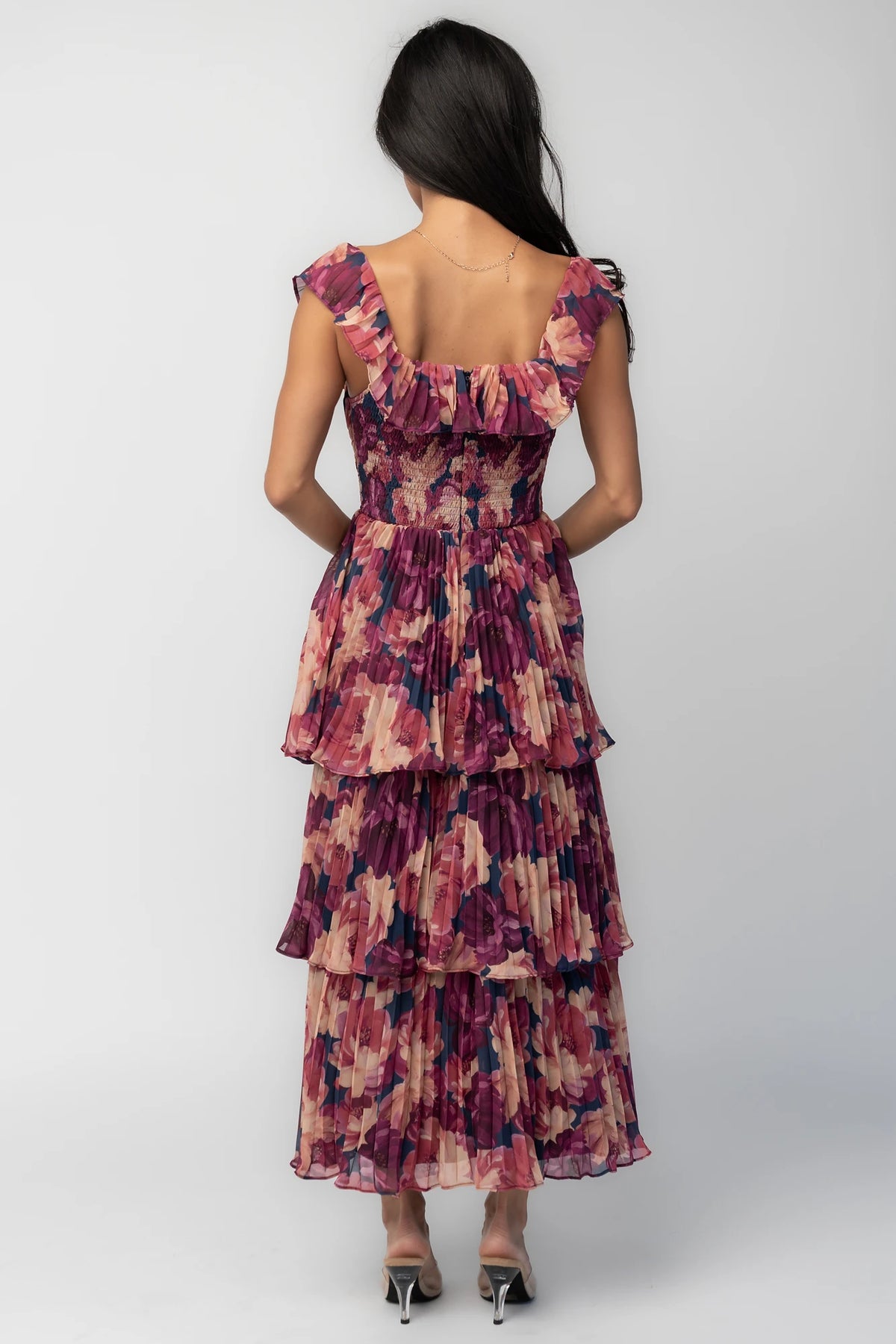 Model wearing the Steinway Pleated Midi Dress in Berry Floral featuring a pink, berry, and mauve floral print on lightweight pleated chiffon.