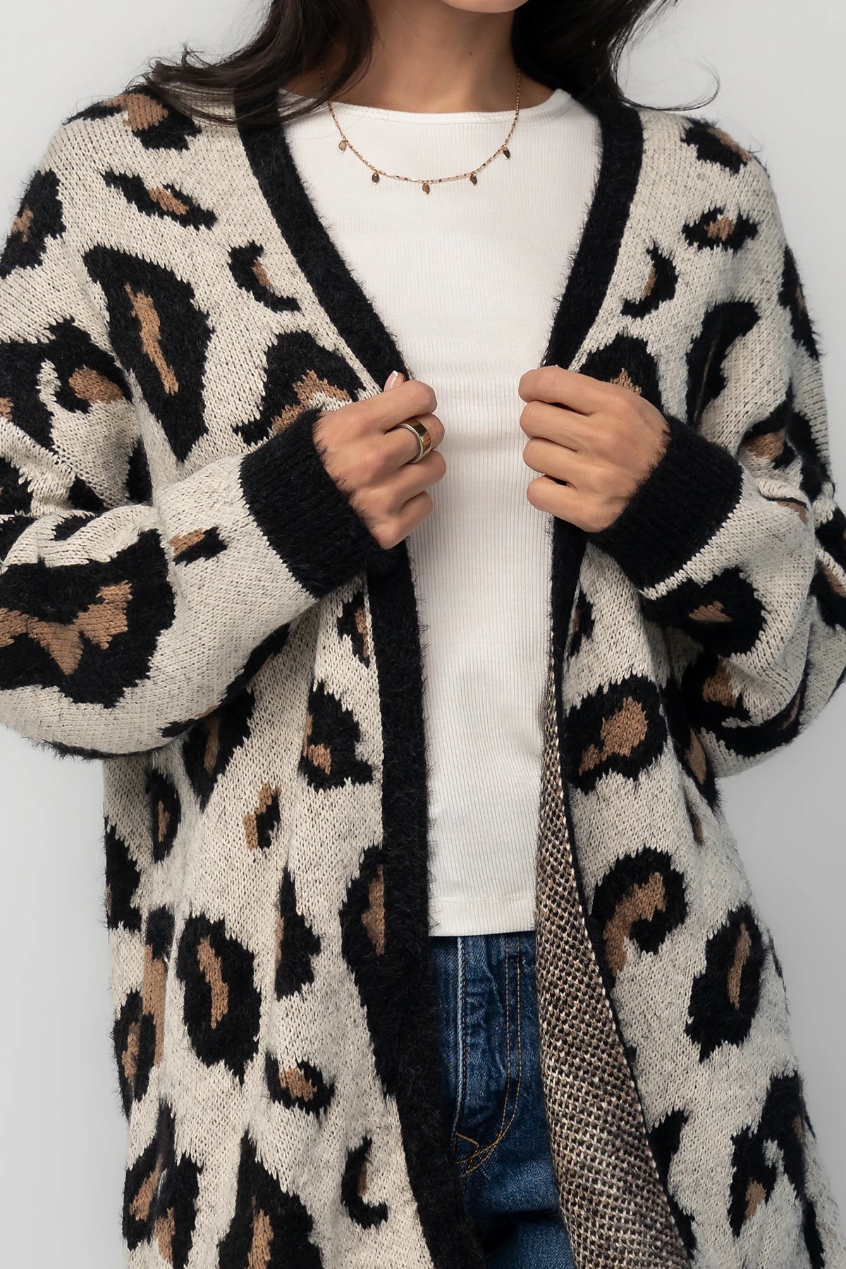 Model wearing the Jeter Open Cardigan in Leopard Print featuring a neutral knit with black and camel leopard print.