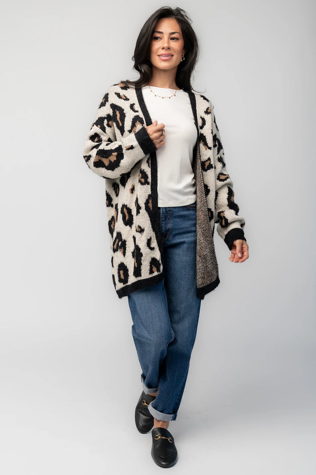 Model wearing the Jeter Open Cardigan in Leopard Print featuring a neutral knit with black and camel leopard print.