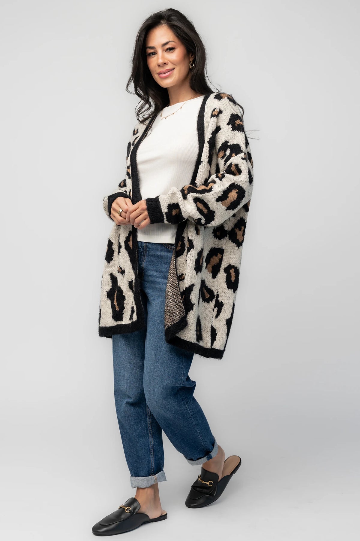 Model wearing the Jeter Open Cardigan in Leopard Print featuring a neutral knit with black and camel leopard print.