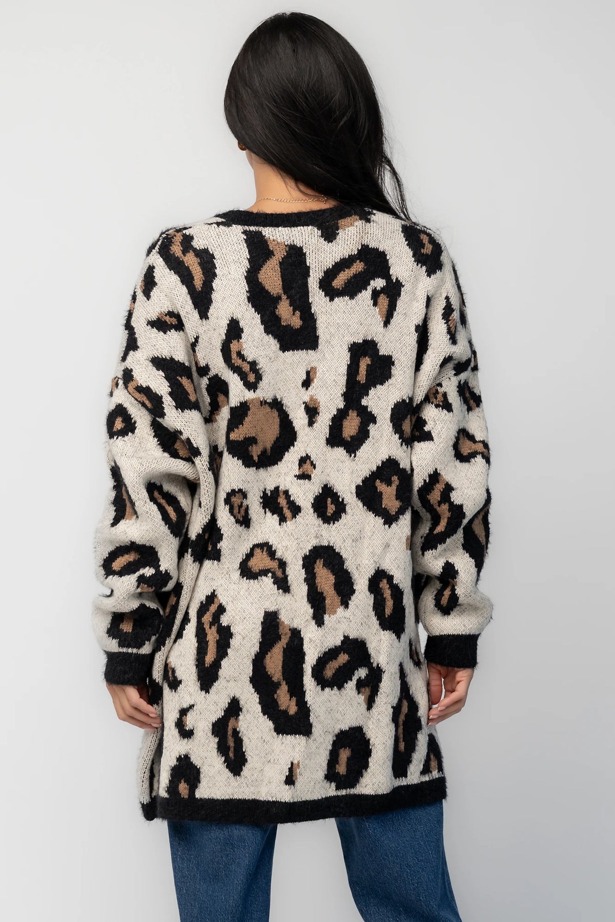Model wearing the Jeter Open Cardigan in Leopard Print featuring a neutral knit with black and camel leopard print.