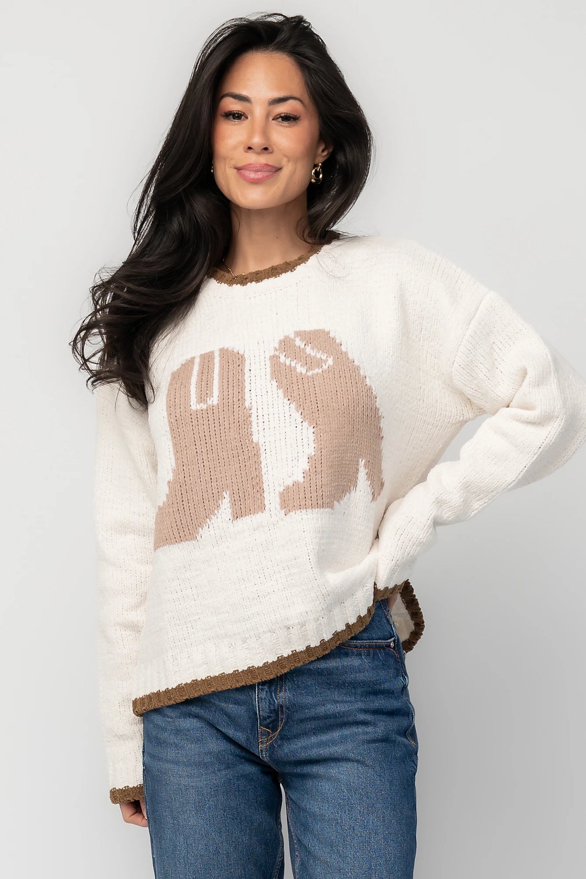 Model wearing the Wild West Knit Sweater in Cream featuring a relaxed fit, Western-inspired yoke detailing, textured knit stitching, long sleeves, and ribbed trim at the neckline, cuffs, and hem.