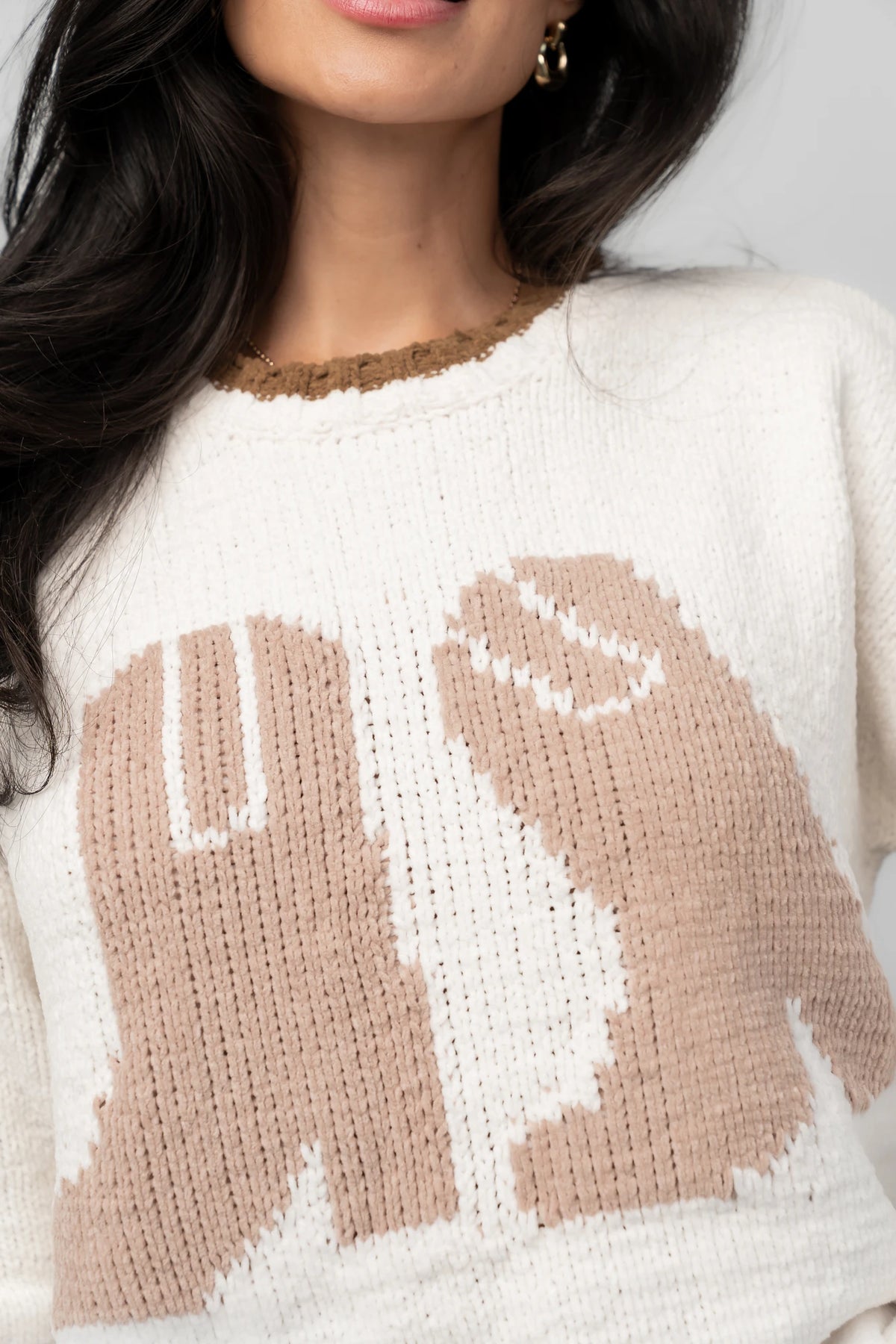 Model wearing the Wild West Knit Sweater in Cream featuring a relaxed fit, Western-inspired yoke detailing, textured knit stitching, long sleeves, and ribbed trim at the neckline, cuffs, and hem.