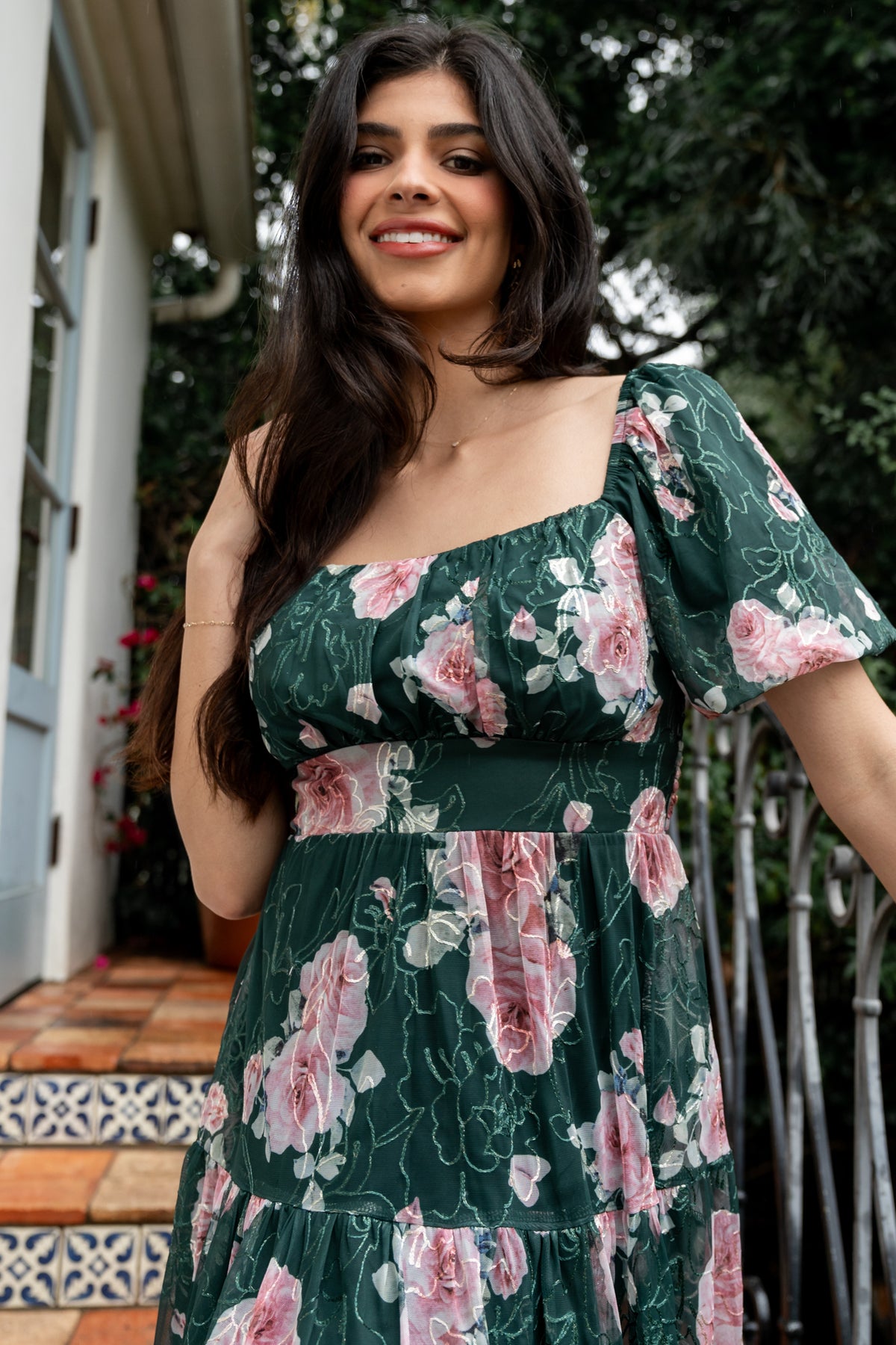 Back view of dress showing smocked back bodice, comfortable stretch fit, and embroidered hem detail on the tulle overlay.