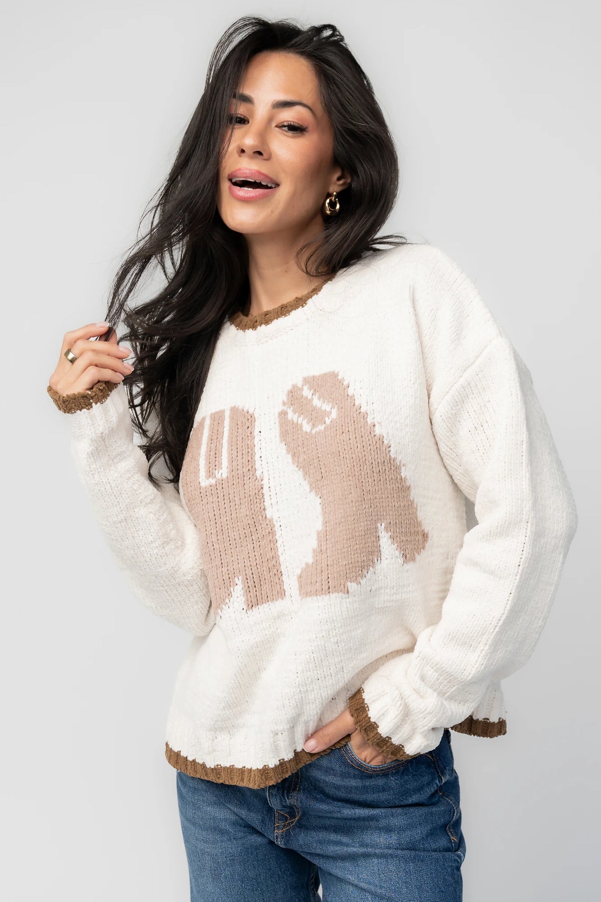 Model wearing the Wild West Knit Sweater in Cream featuring a relaxed fit, Western-inspired yoke detailing, textured knit stitching, long sleeves, and ribbed trim at the neckline, cuffs, and hem.
