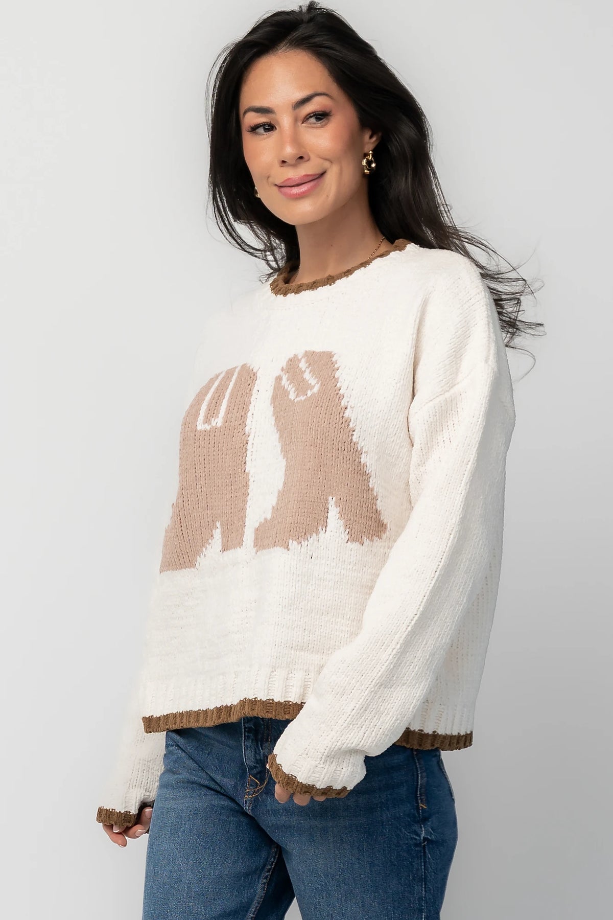 Model wearing the Wild West Knit Sweater in Cream featuring a relaxed fit, Western-inspired yoke detailing, textured knit stitching, long sleeves, and ribbed trim at the neckline, cuffs, and hem.