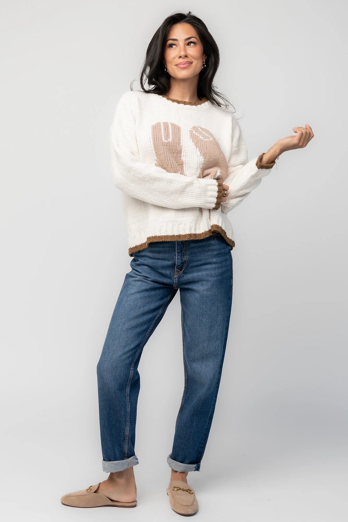 Model wearing the Wild West Knit Sweater in Cream featuring a relaxed fit, Western-inspired yoke detailing, textured knit stitching, long sleeves, and ribbed trim at the neckline, cuffs, and hem.