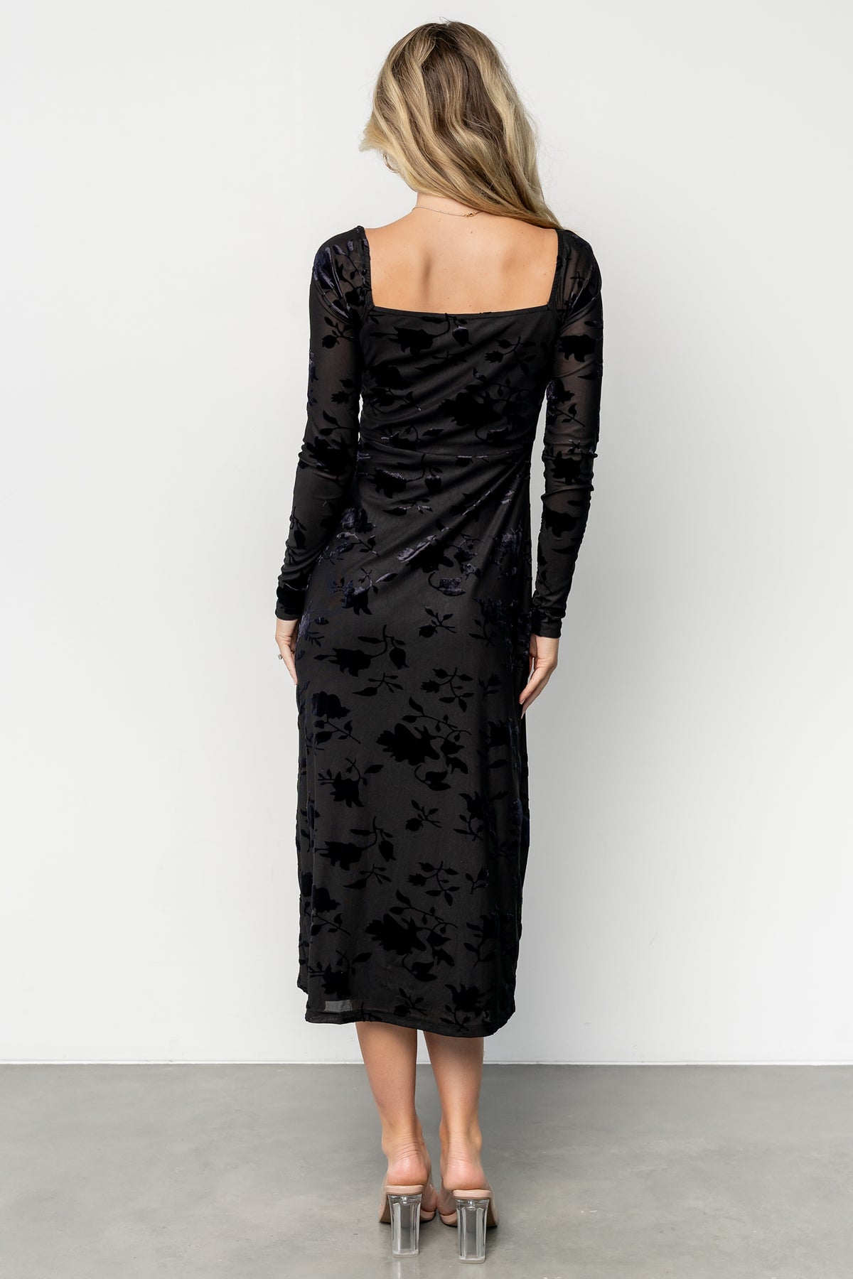 Close-up of embossed floral velvet texture and square neckline on the Tamara midi dress in black floral pattern.
