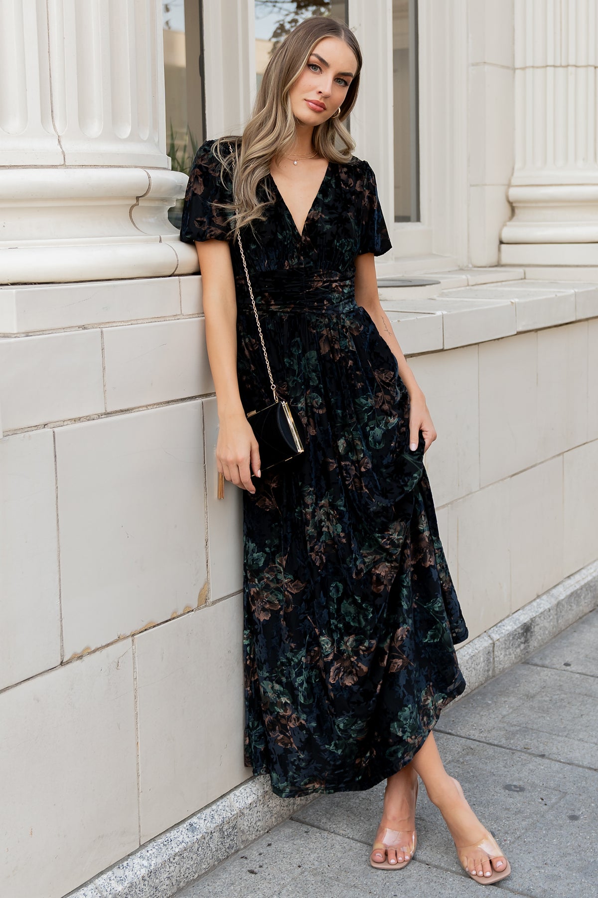 Front view of model wearing Leslie Velvet Maxi Dress in Black and Deep Jade Floral; V-neck, short puff sleeves, and full-length silhouette (studio lighting).