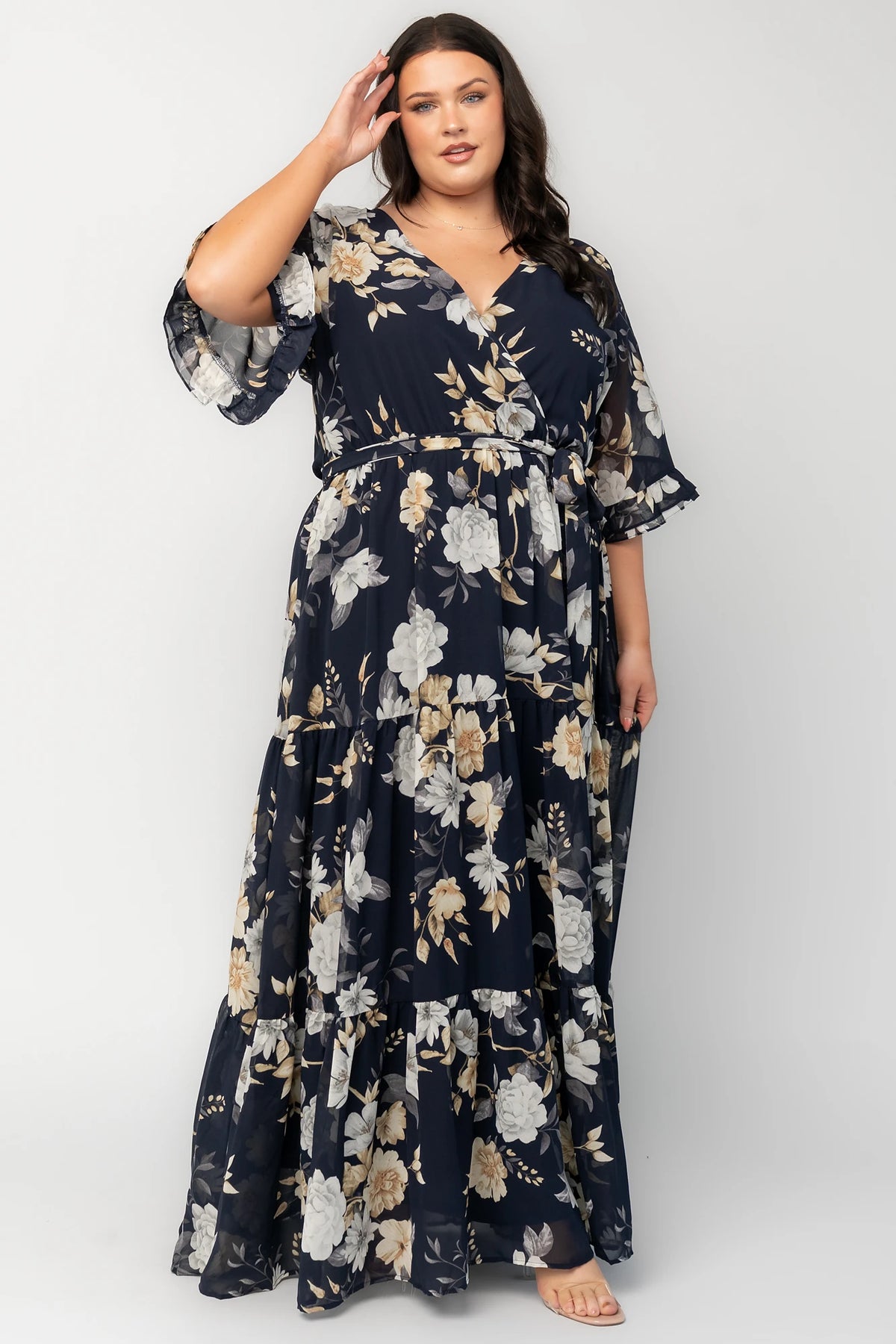 Luna Maxi Dress in Navy Floral with surplice V-neck, flutter sleeves, sash waist, and flowing tiered skirt.