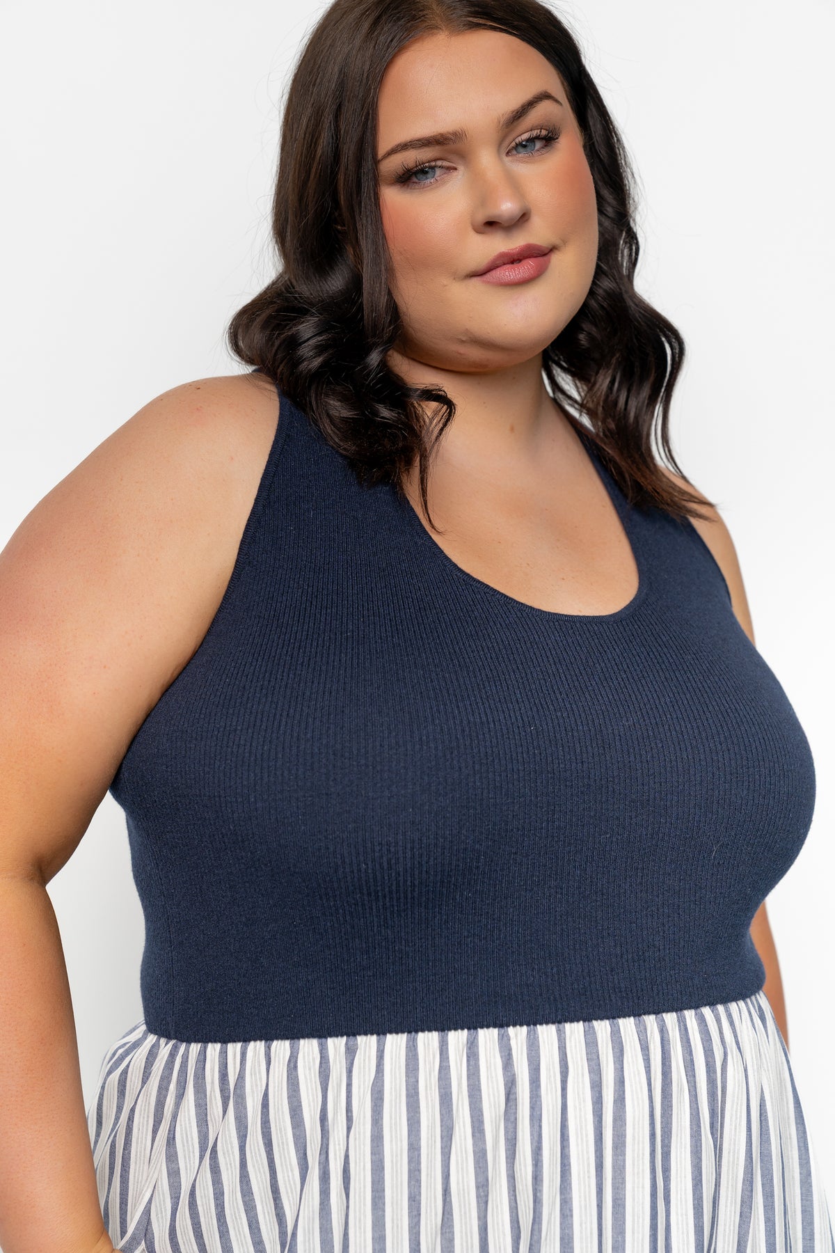 Side view of Marbella Tank Midi Dress in navy stripe illustrating hidden side pocket, midi hem, and natural waist shaping.