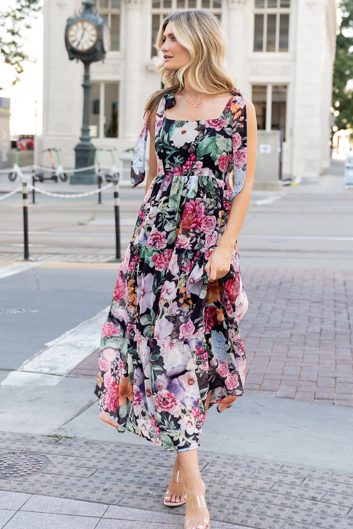 Three-quarter view of the Anita Maxi Dress highlighting the chiffon overlay, ruffled tiers, and the maxi-length silhouette in black multi floral.
